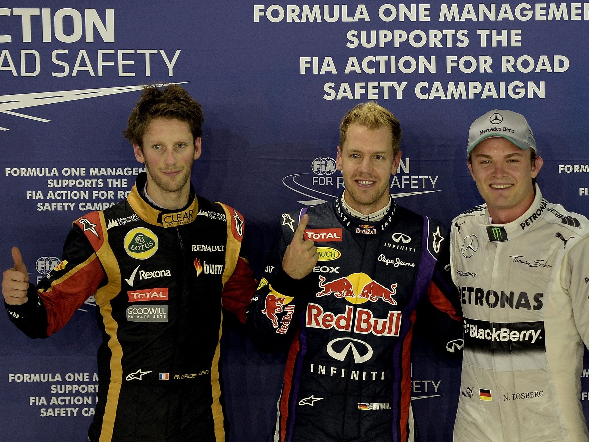 SINGAPORE - SEPTEMBER 21: Sebastian Vettel (C) of Germany and Infiniti Red Bull racing celebrates his pole position with Romain Grosjean (L) of France and Lotus and Nico Rosberg (R) of Germany and Mercedes GP after qualifying for the Singapore Formula One Grand Prix. GETTY IMAGES