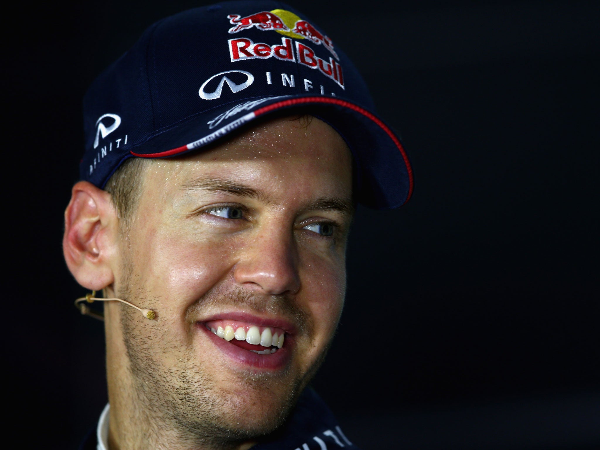 SINGAPORE - SEPTEMBER 21:Sebastian Vettel of Germany and Infiniti Red Bull Racing speaks to the media after qualifying on Pole Position for the Singapore Formula One Grand Prix at Marina Bay Street Circuit. GETTY IMAGES