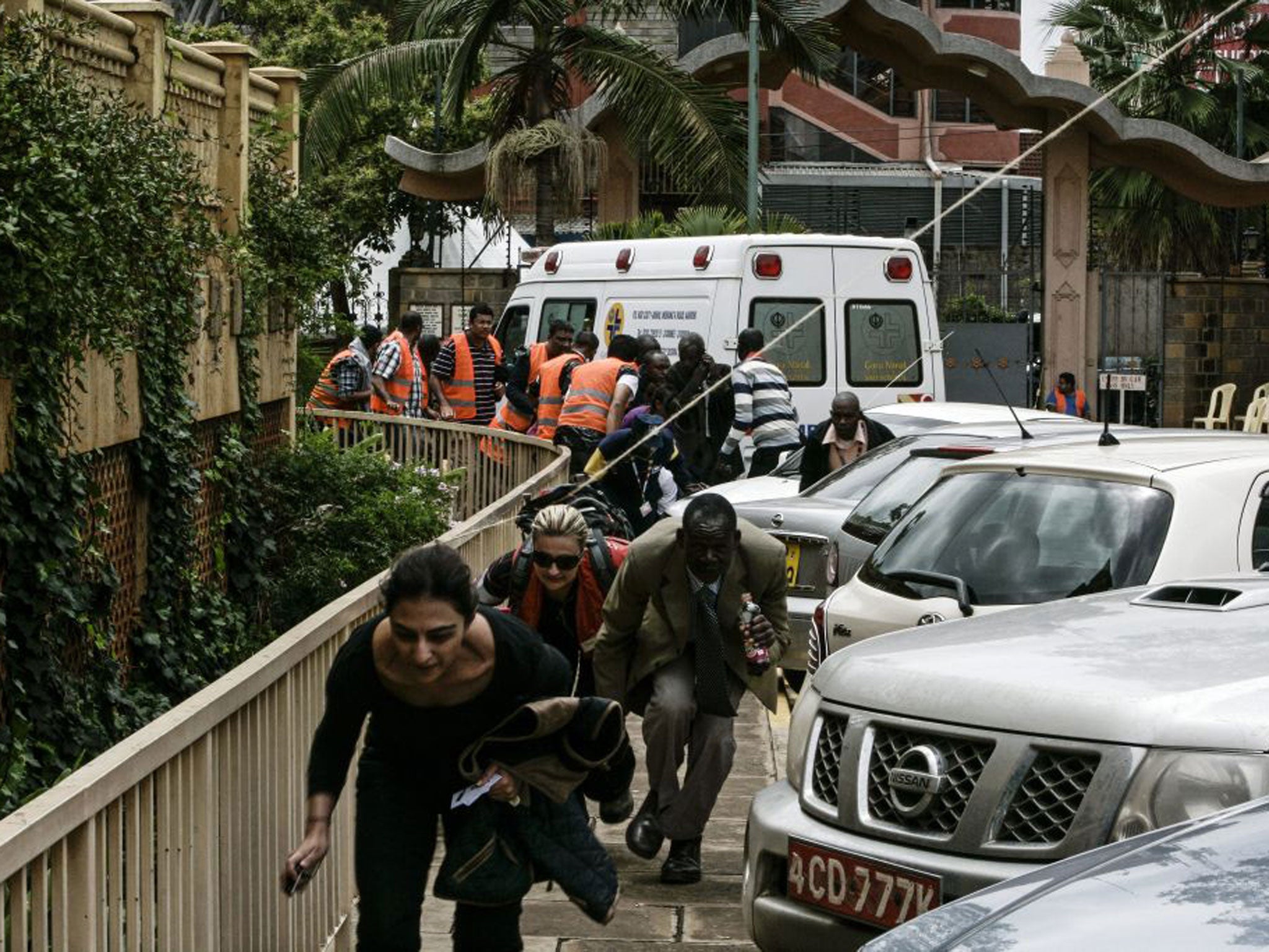 People run for cover after hearing gunshots near the Westgate shopping centre