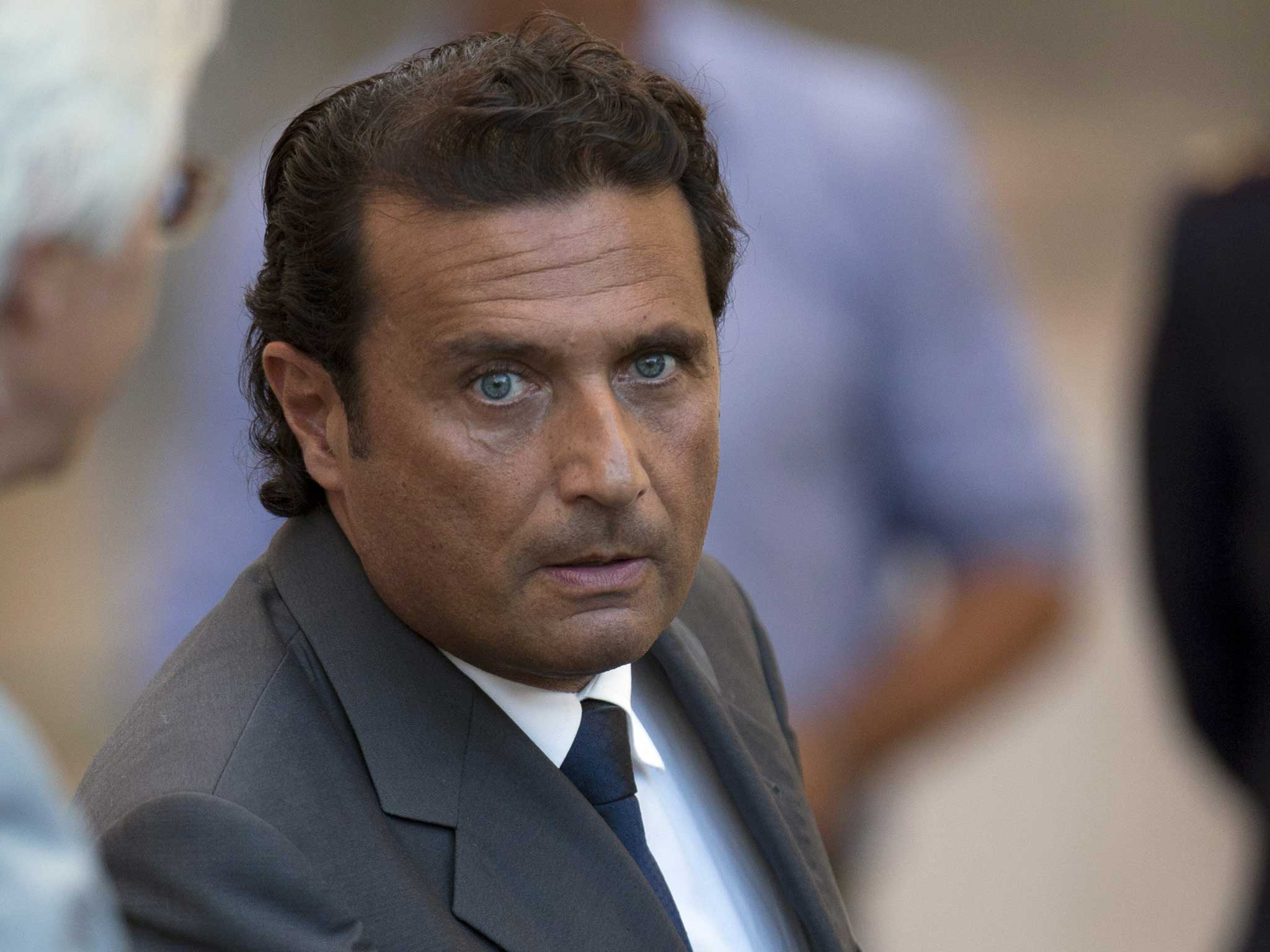 Captain Francesco Schettino leaves the court room