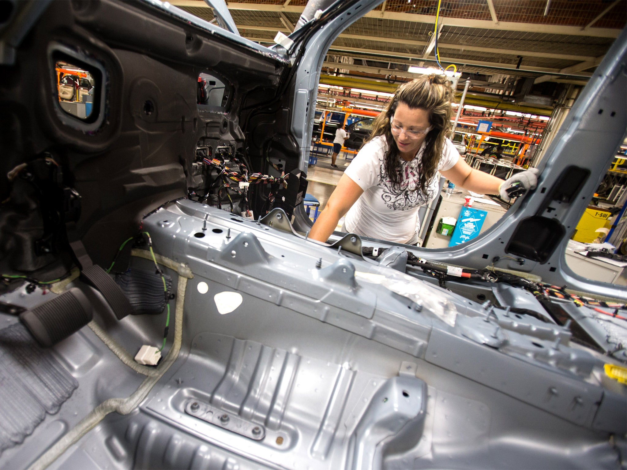 A worker at the Jefferson North plant inspects wiring on a Jeep, which has been one of the key drivers of Chrysler’s turnaround