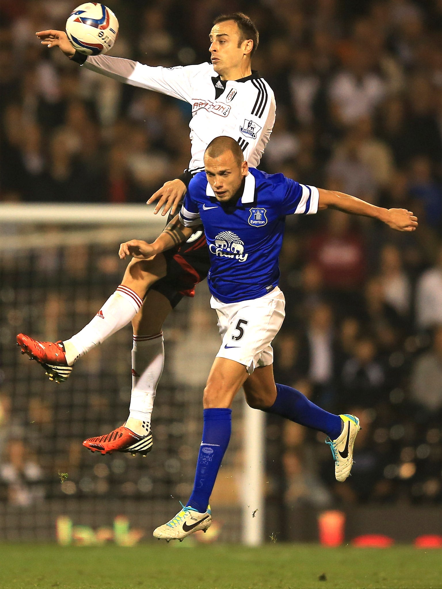 Dimitar Berbatov of Fulham rises above Everton’s John Heitinga