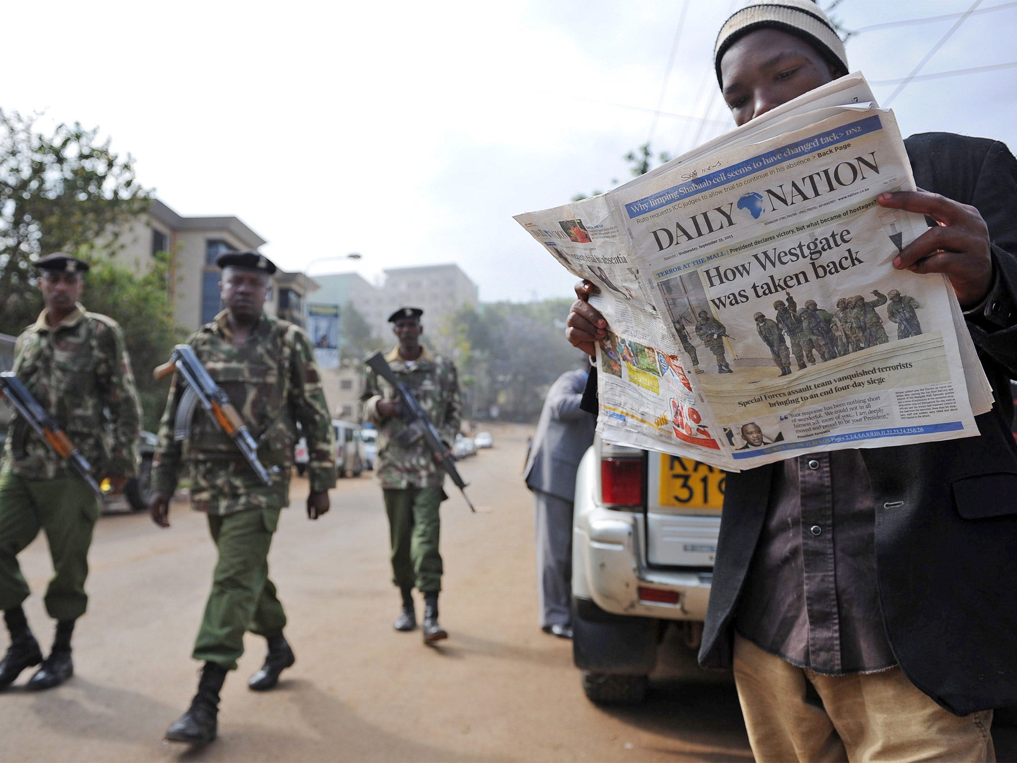 A man reads the story of how the siege came to an end (Getty)