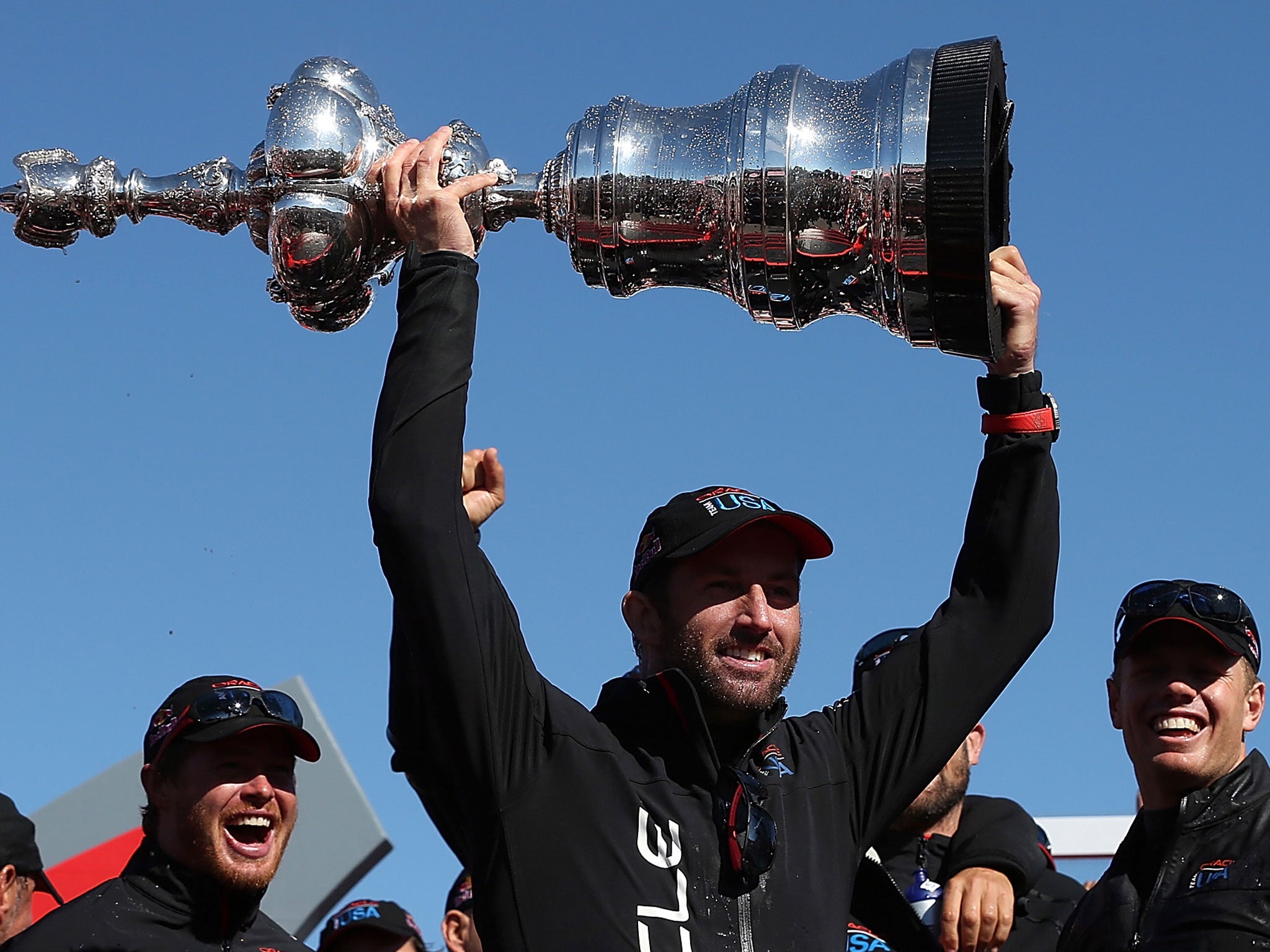 Oracle Team USA tactician Sir Ben Ainslie holds aloft the America's Cup trophy