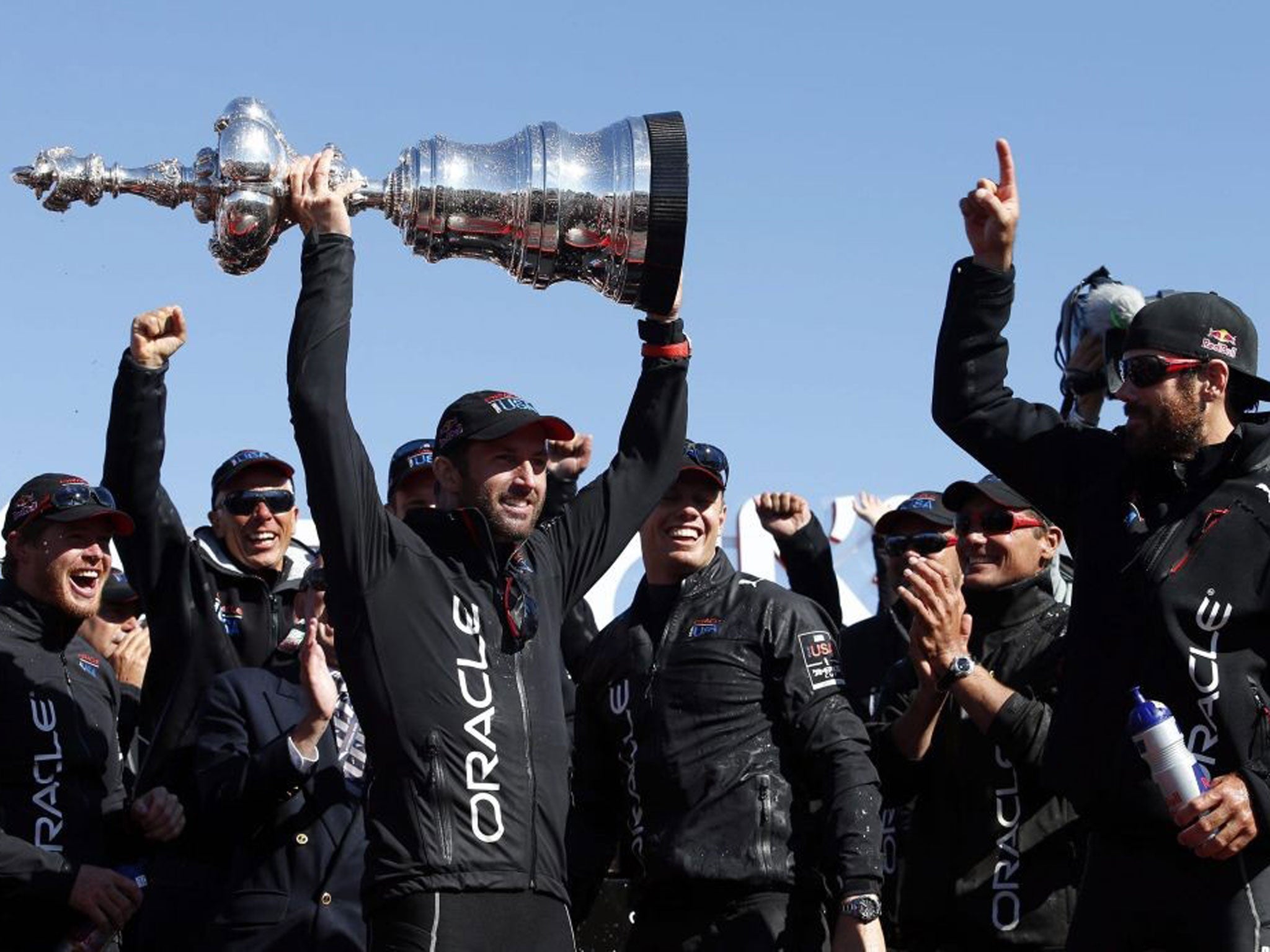 Ben Ainslie collects the mammoth Americas Cup trophy