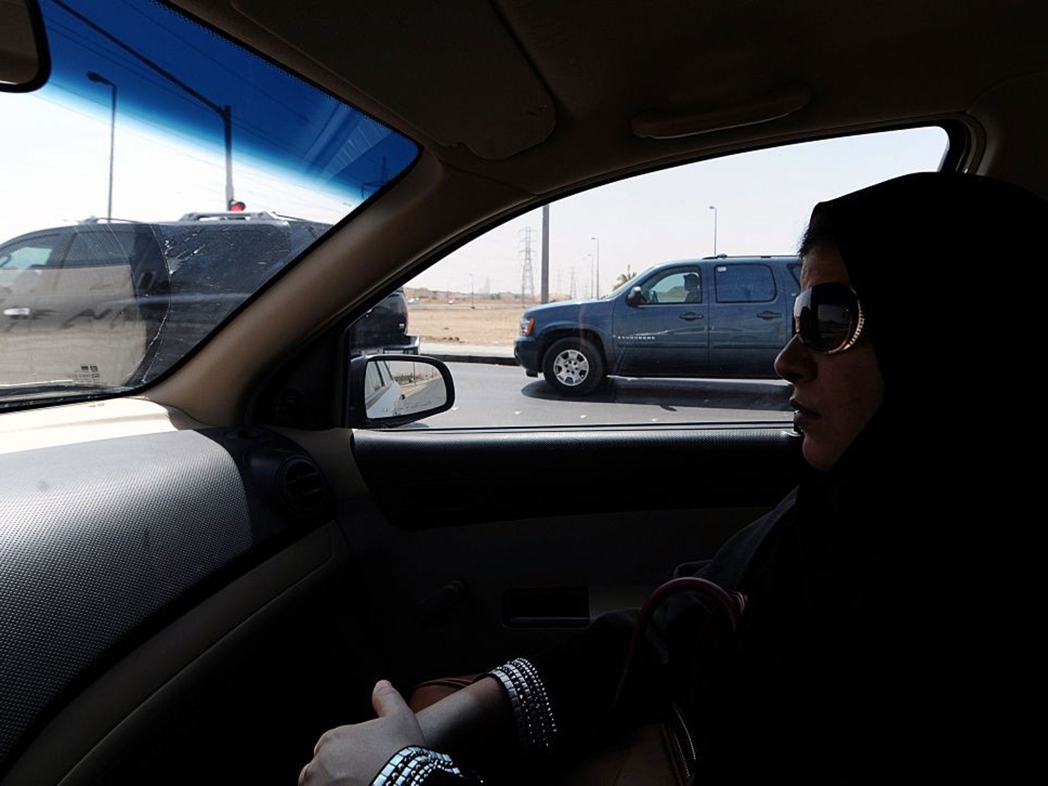 A Saudi woman sits in a car in Riyadh: After activists called for a day of defiance against women driving ban, a senior cleric says it damages their ovaries and unborn children