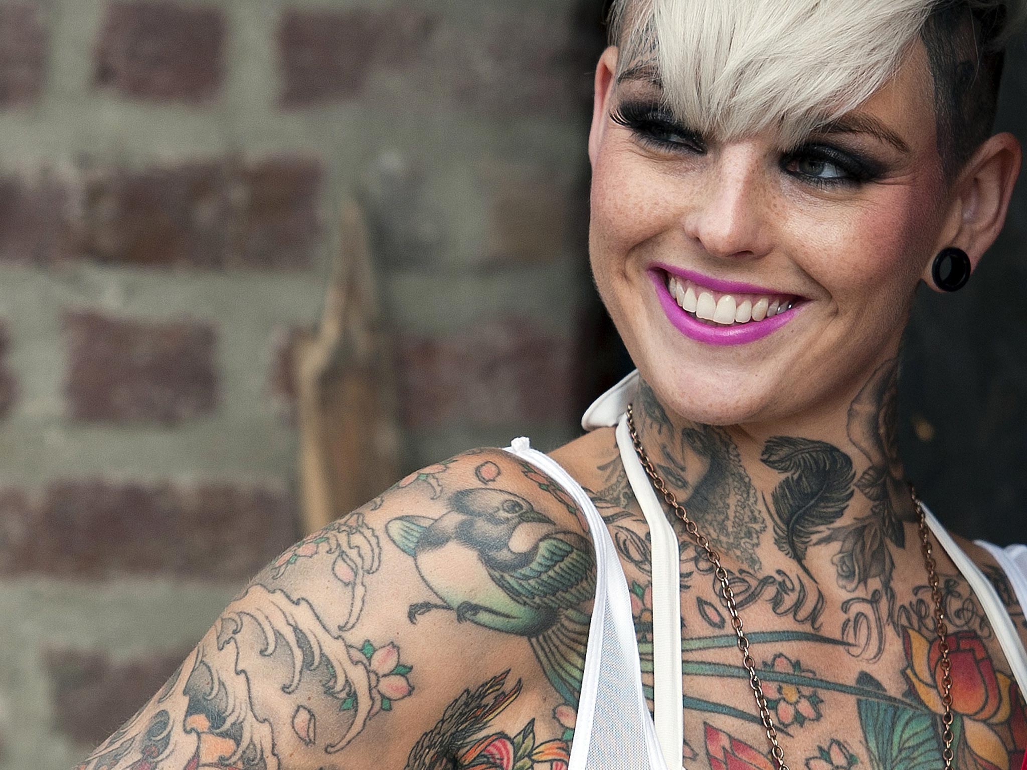 A tattoo enthusiast poses at the London Tattoo Convention in London