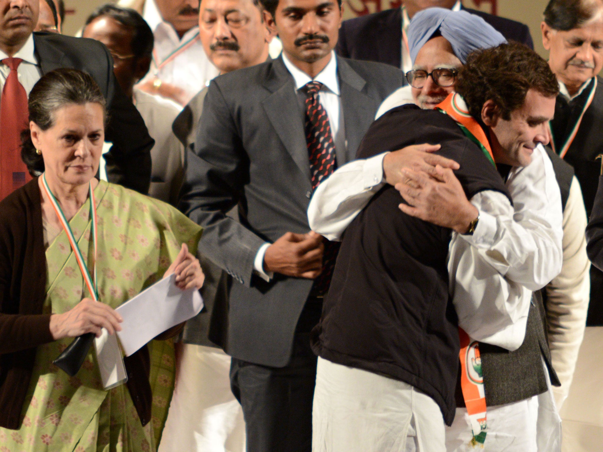 Rahul Gandhi hugs Indian Prime Minister Manmohan Singh, before delivering his first speech as Congress party Vice-President, while Gandhi's mother and Congress Party President Sonia Gandhi looks on.