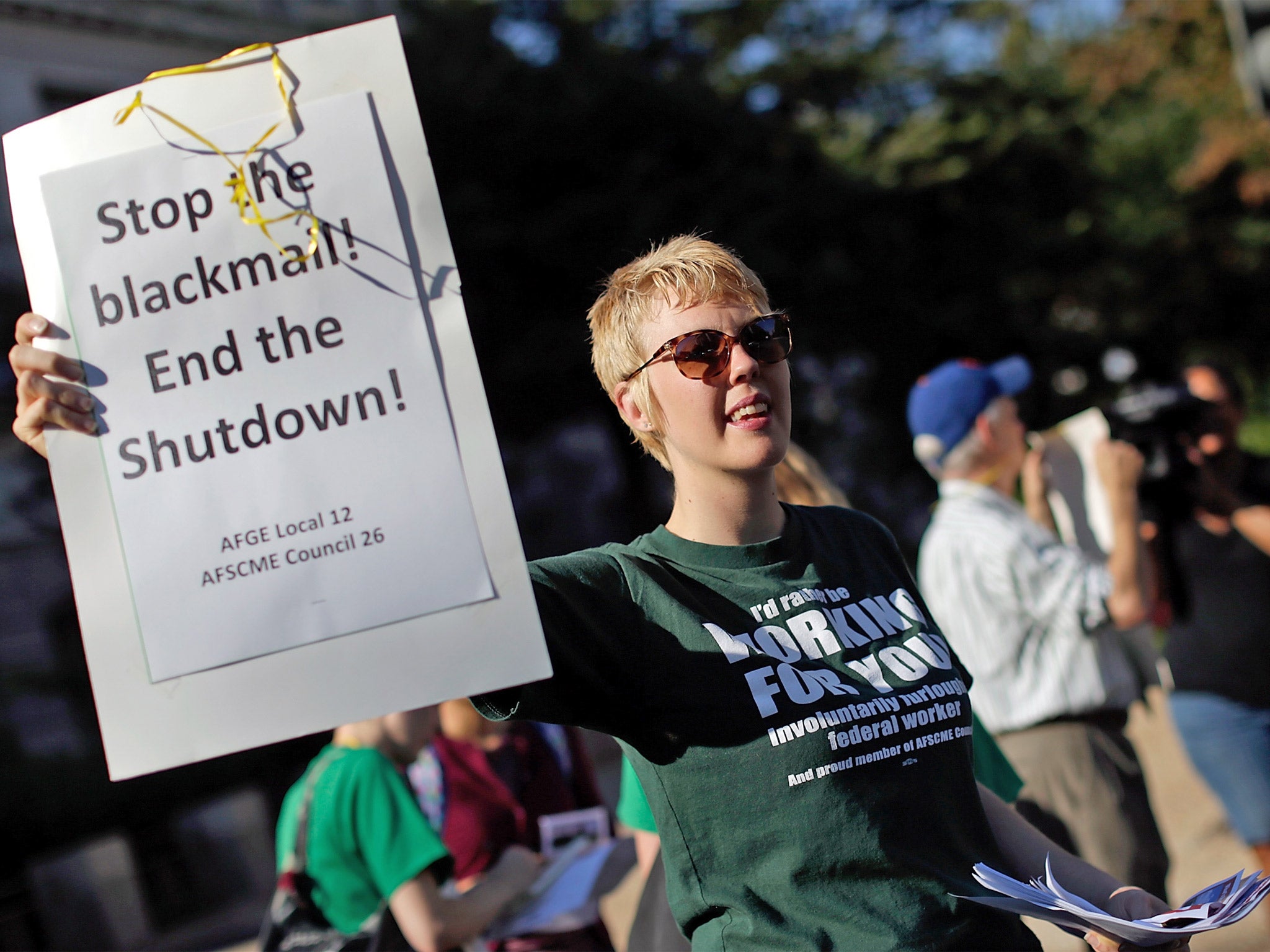 Government union workers demonstrate on the side of Constitution Avenue