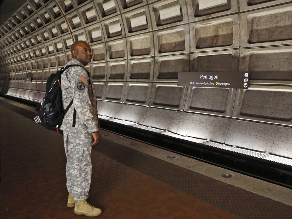 'Maybe this time I'll get a seat': A soldier waits for his train during rush hour at the Pentagon Metro station