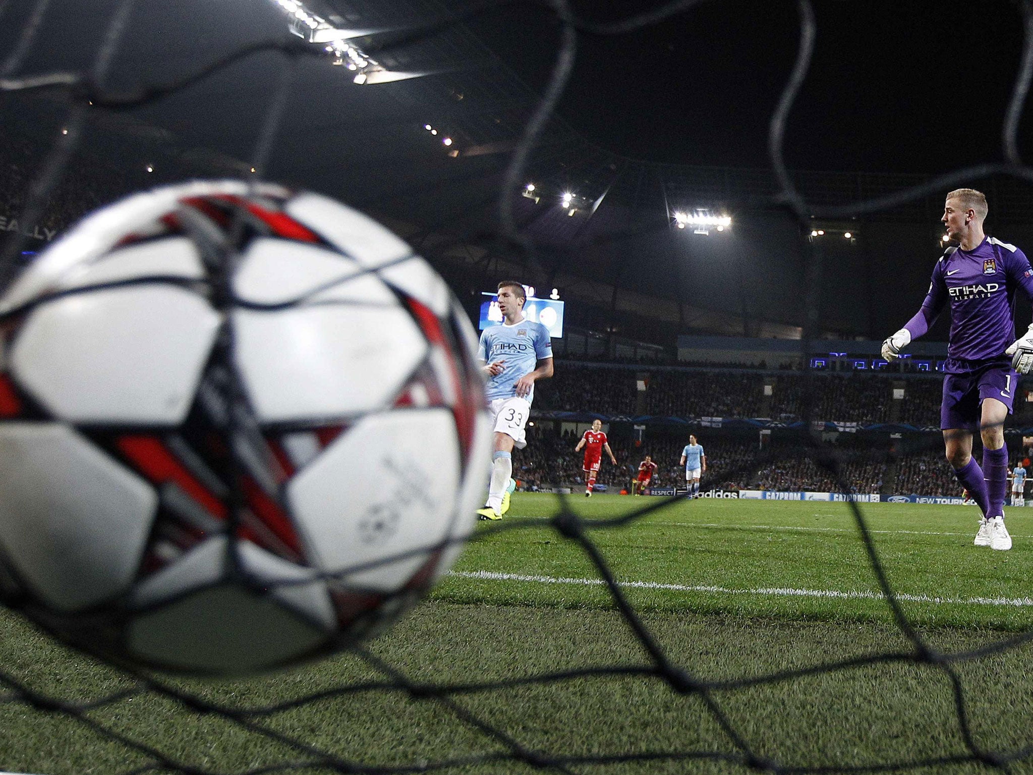 Joe Hart (right) looks on after Thomas Müller scored Bayern's second goal