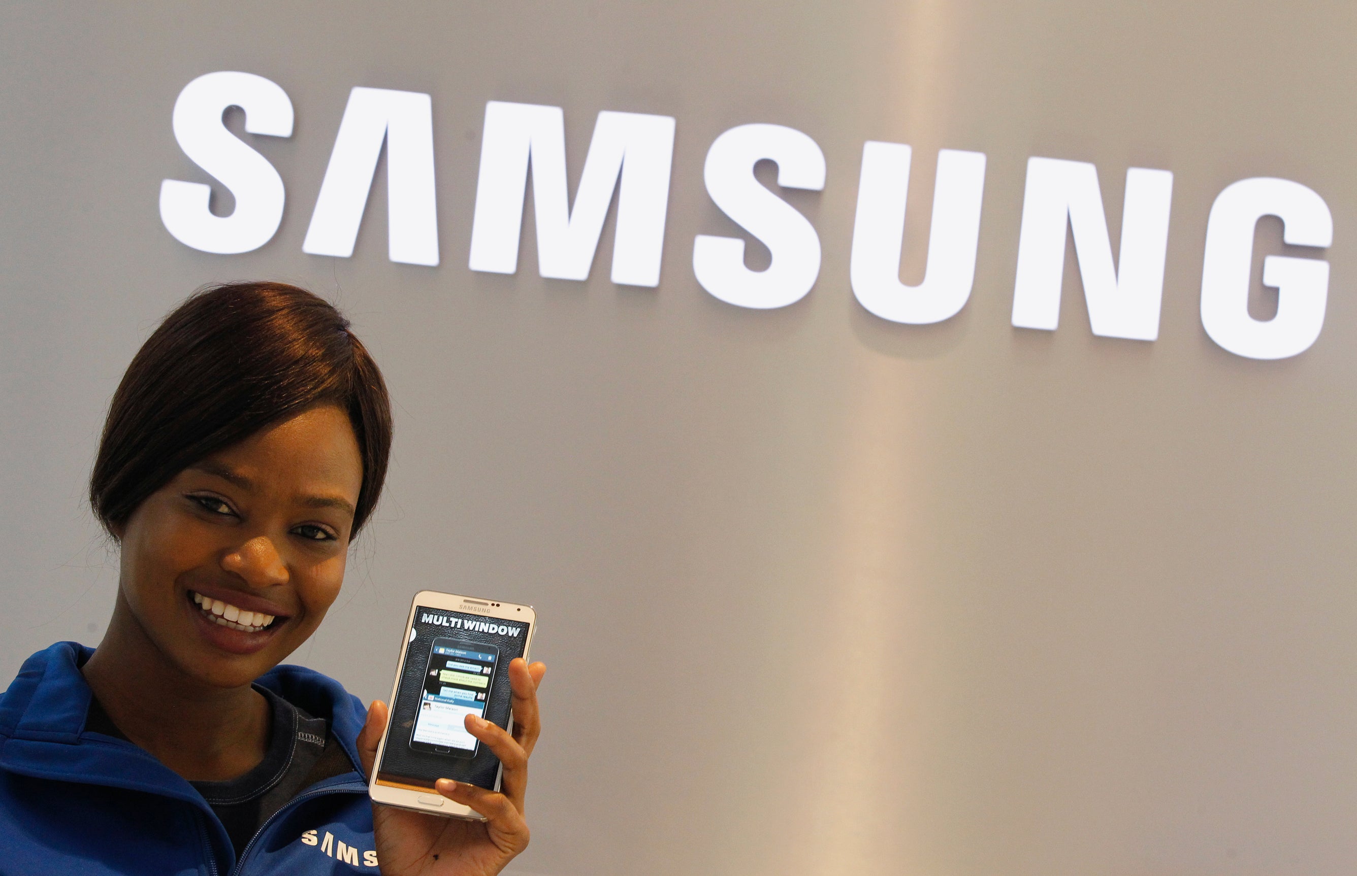 A Samsung employee holds a mobile phone at a Samsung display store in Johannesburg, October 3,