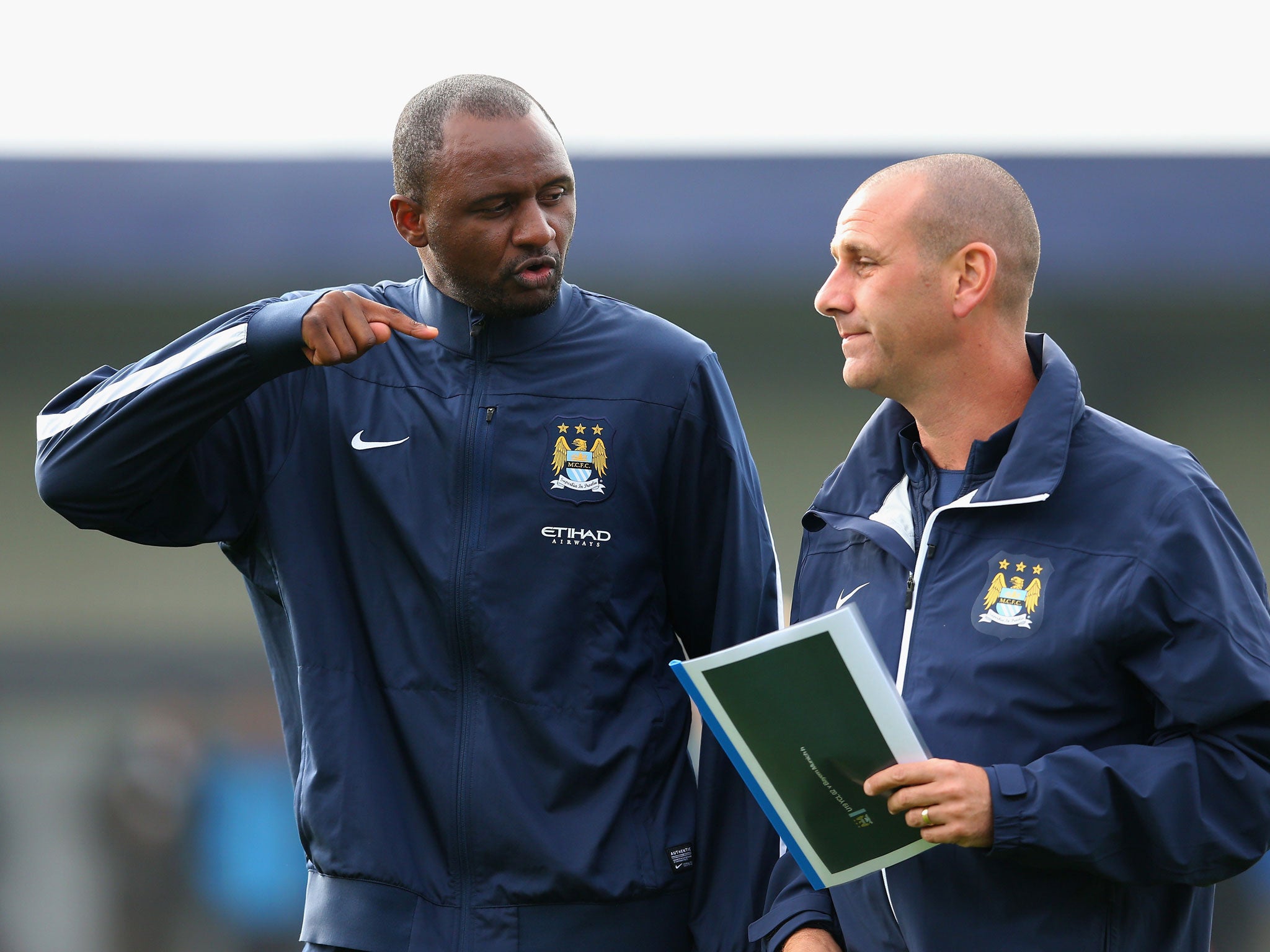 Patrick Vieira (left) talks tactics with assistant coach Simon Davies