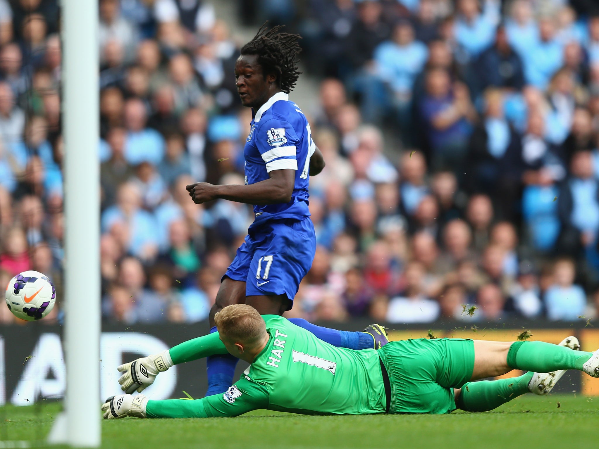 Joe Hart dives to try and save a shot from Romelu Lukaku