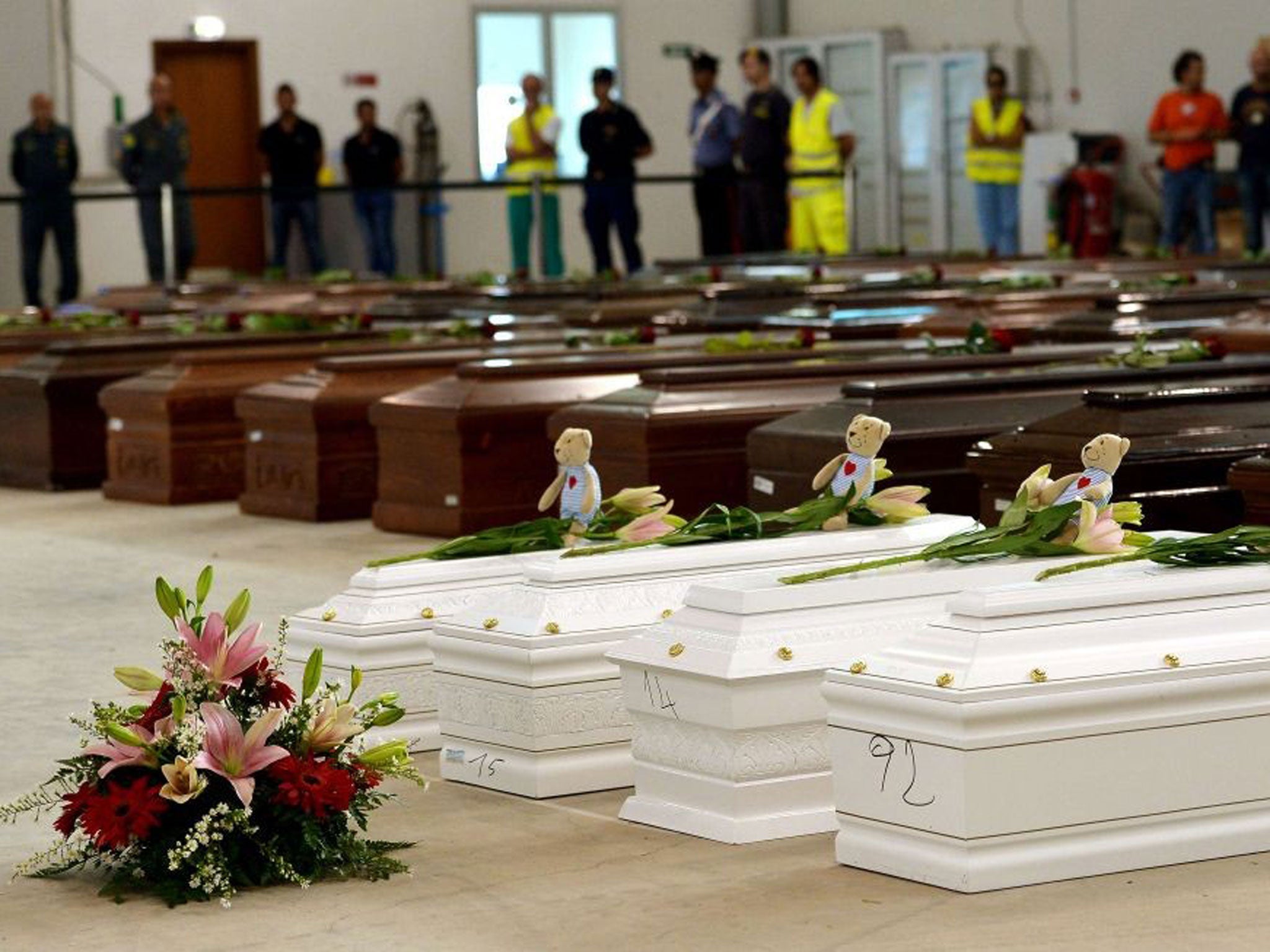 Coffins of children among the adult victims in a hangar of Lampedusa airport