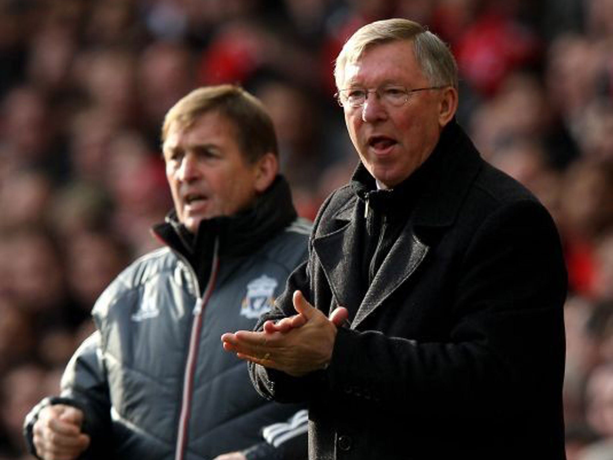 From the sidelines: Kenny Dalglish (left) and Sir Alex Ferguson watch on