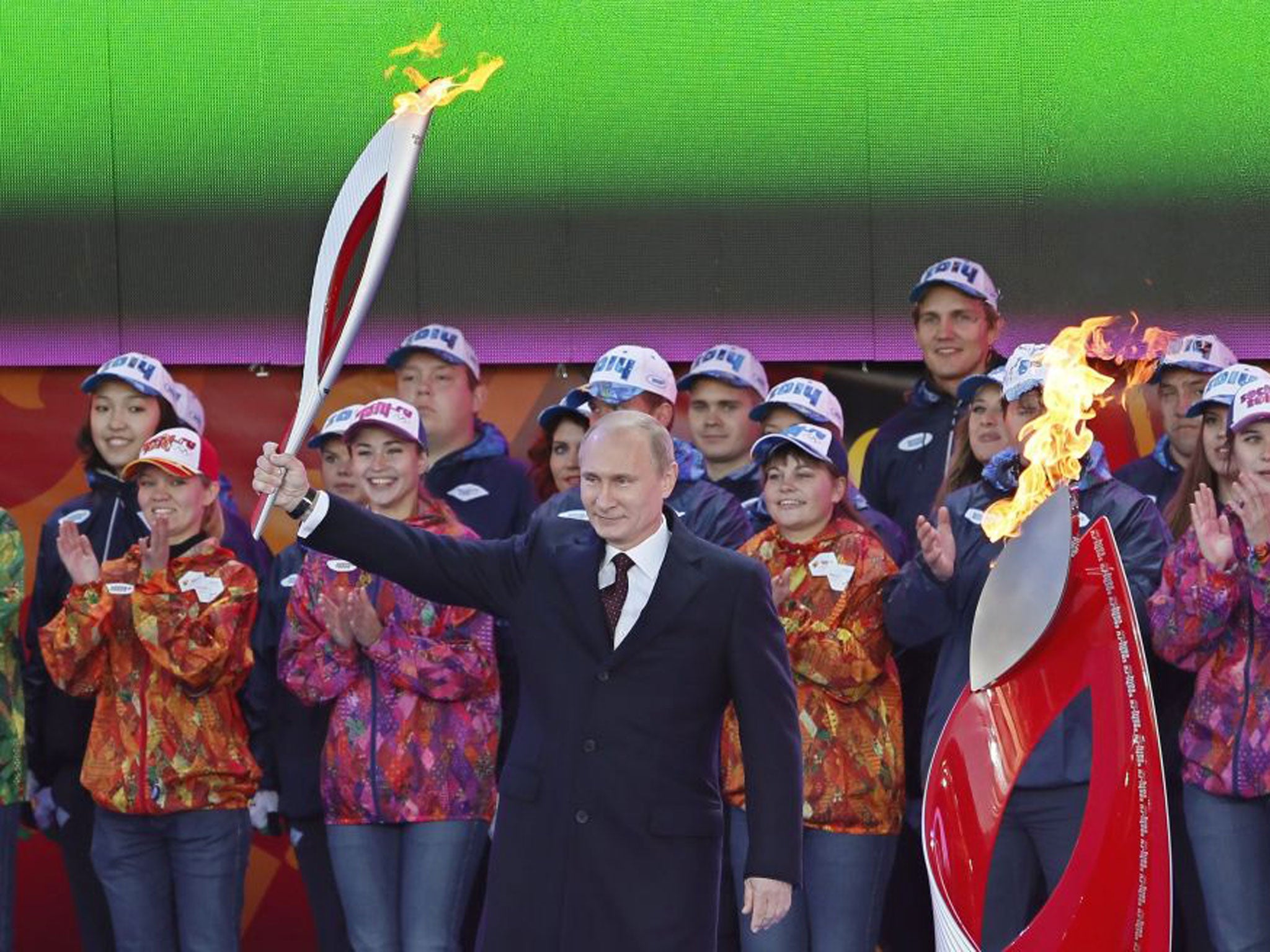 Vladimir Putin with the Olympic torch at a ceremony in Moscow yesterday