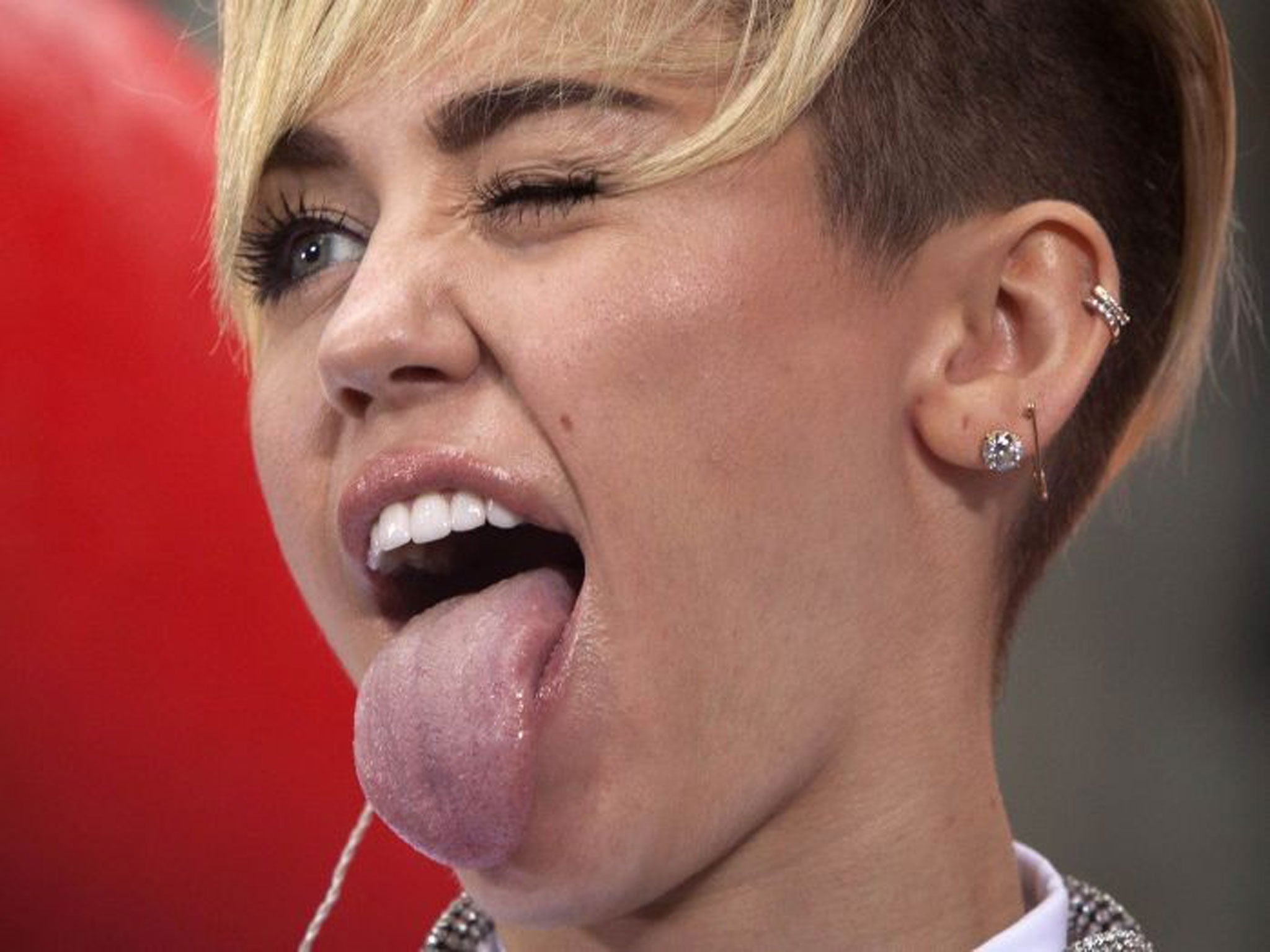 Miley Cyrus has caused controversy by saying she sticks out her tongue so much because she 'keeps having mini strokes'