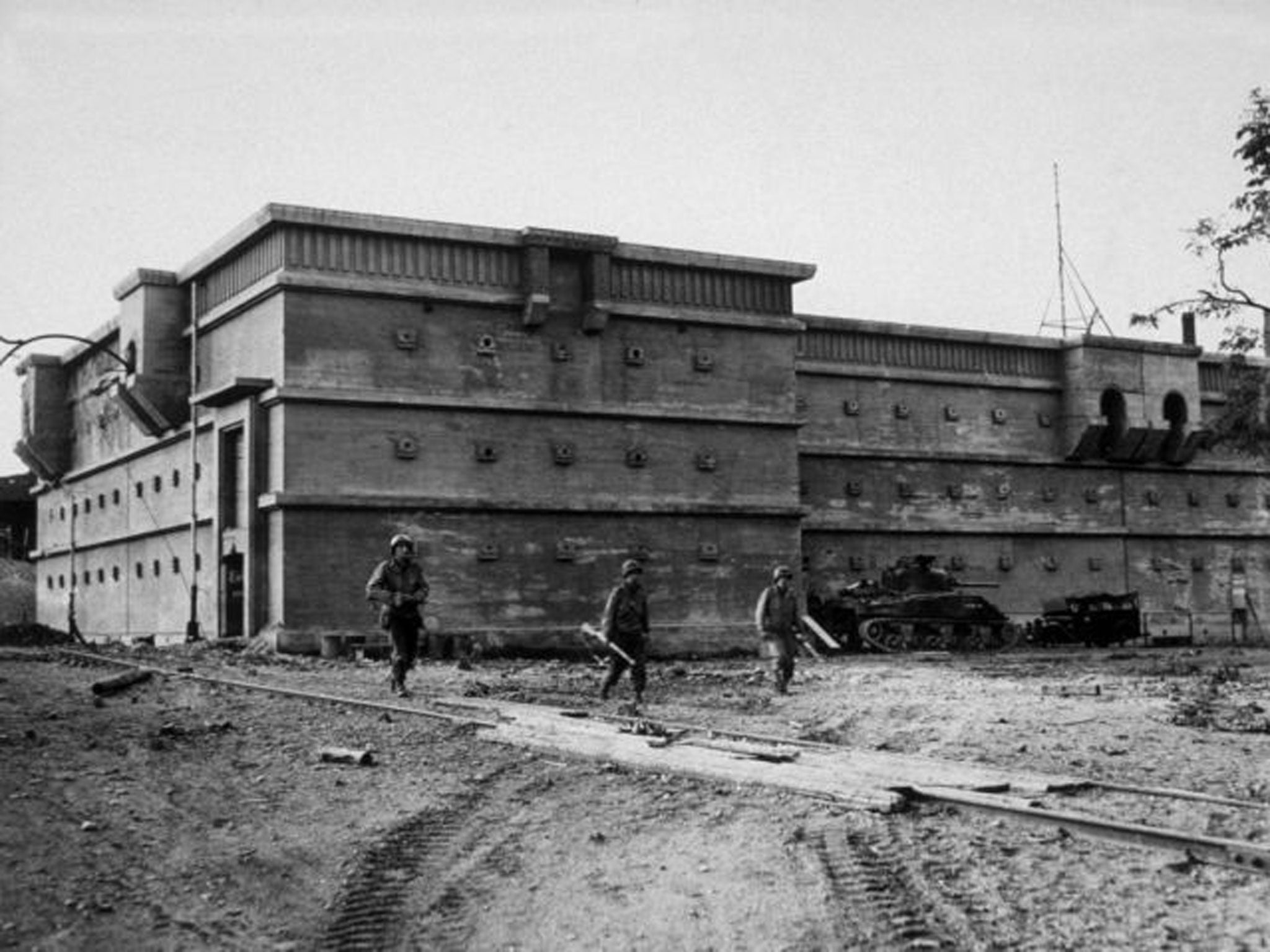 American troops seen in front of a vast air raid shelter in Aachen, Germany, 1945