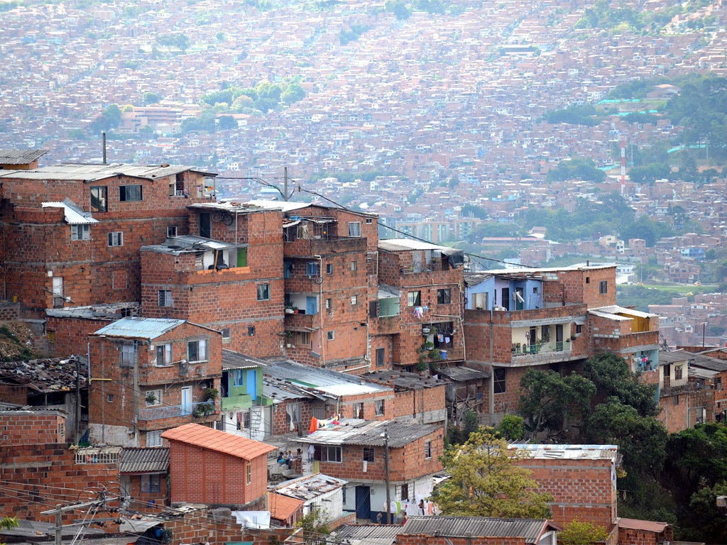 Commune 1 - a shantytown with one of the highest rates of urban violence and displacement due to disputes between gangs - in Medellin (Getty)