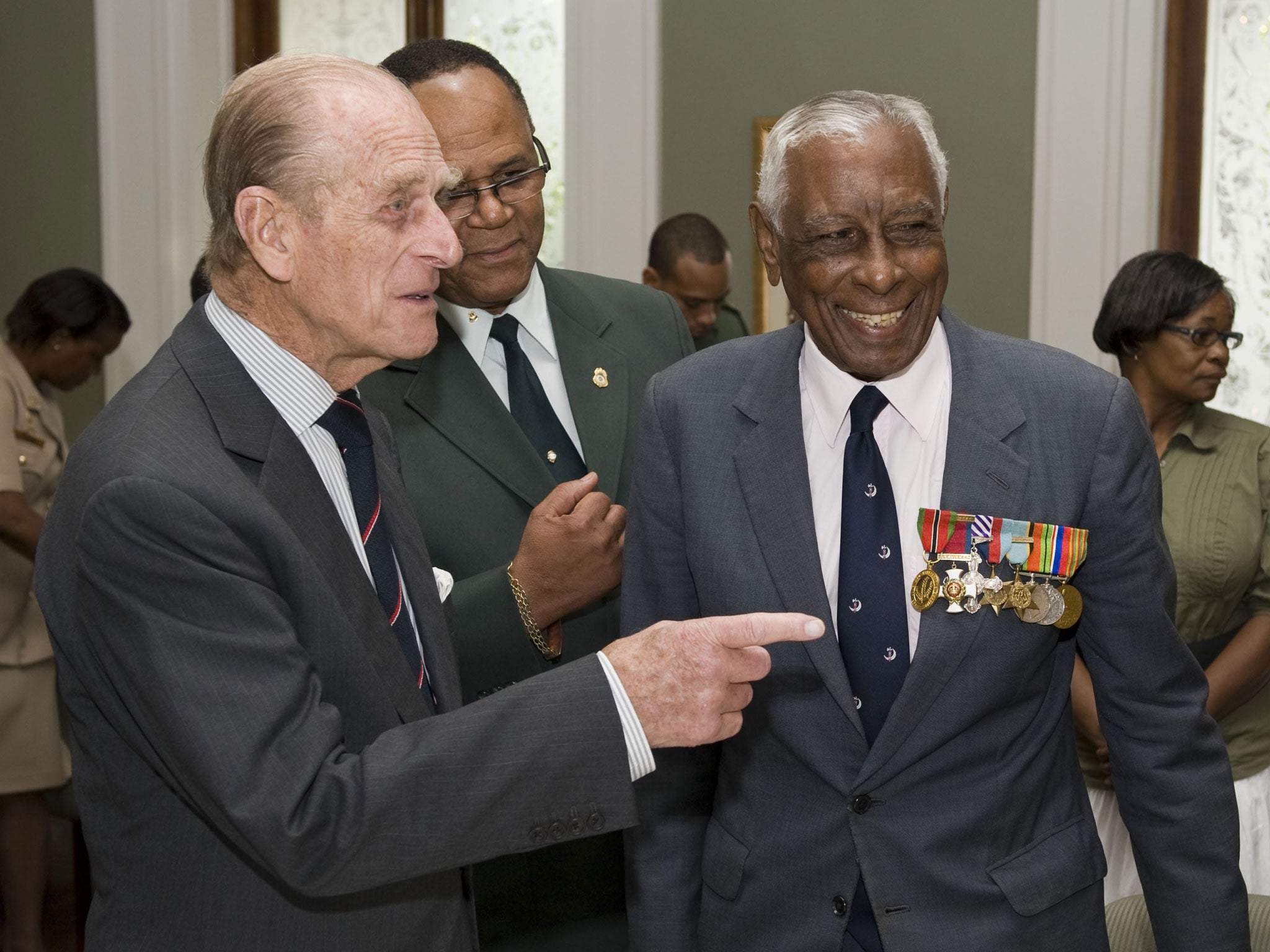 A bemedalled Cross with Prince Philip during a Royal visit to Trinidad and Tobago in 2009