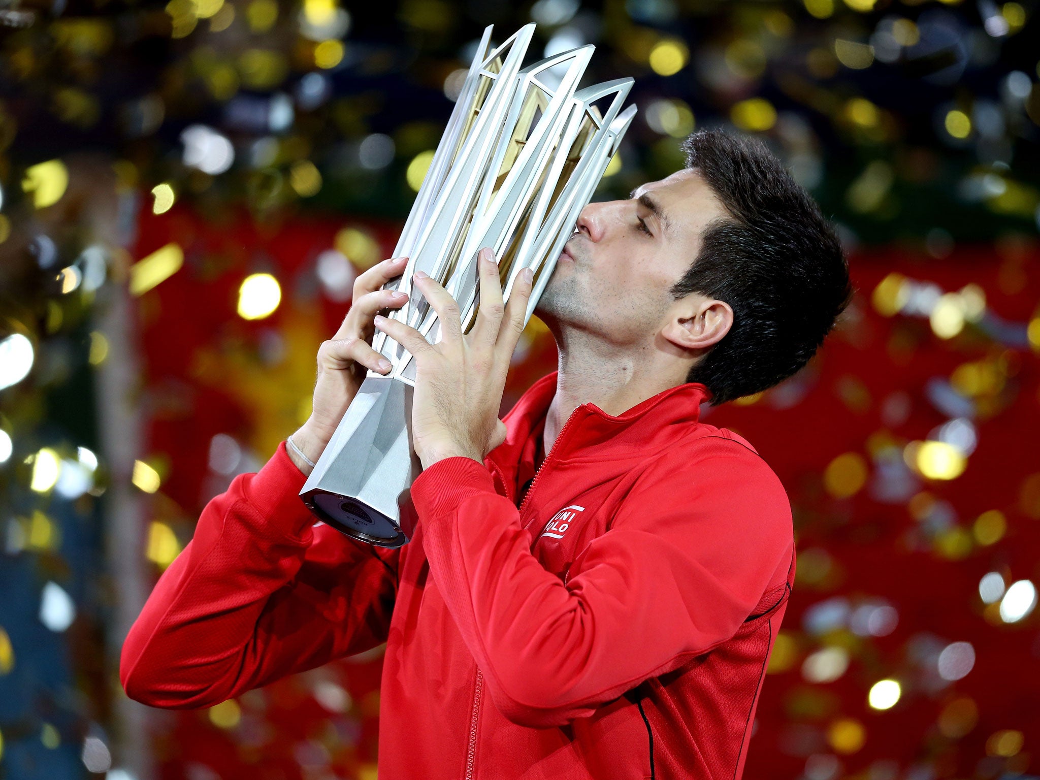 SHANGHAI, CHINA - OCTOBER 13: Novak Djokovic of Serbia poses for photographers with the winner's trophy after defeating Juan Martin Del Potro of Argentina during the final of the Shanghai Rolex Masters