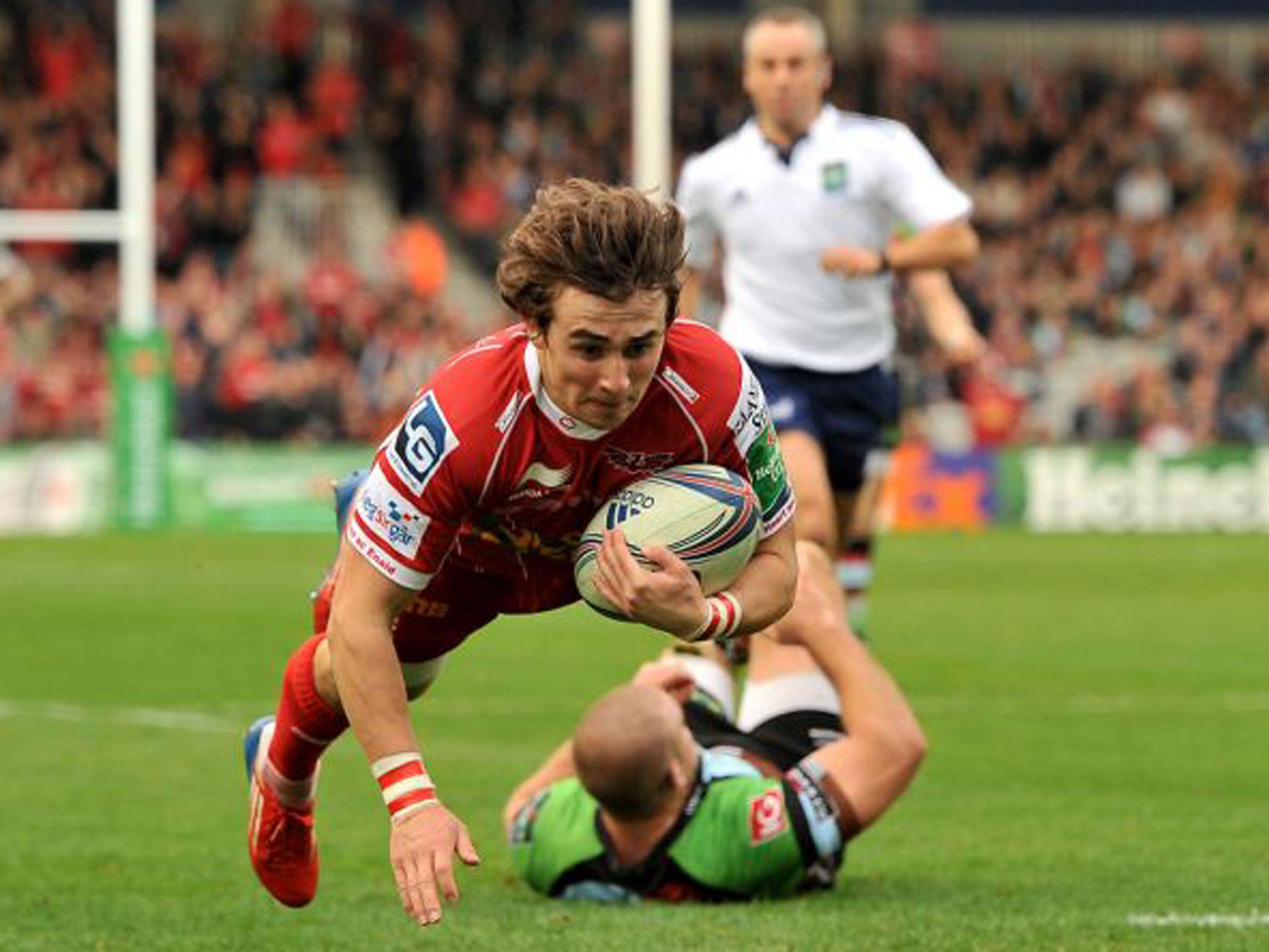 Scarlets’ Rhodri Williams dives in to score the first try on Saturday