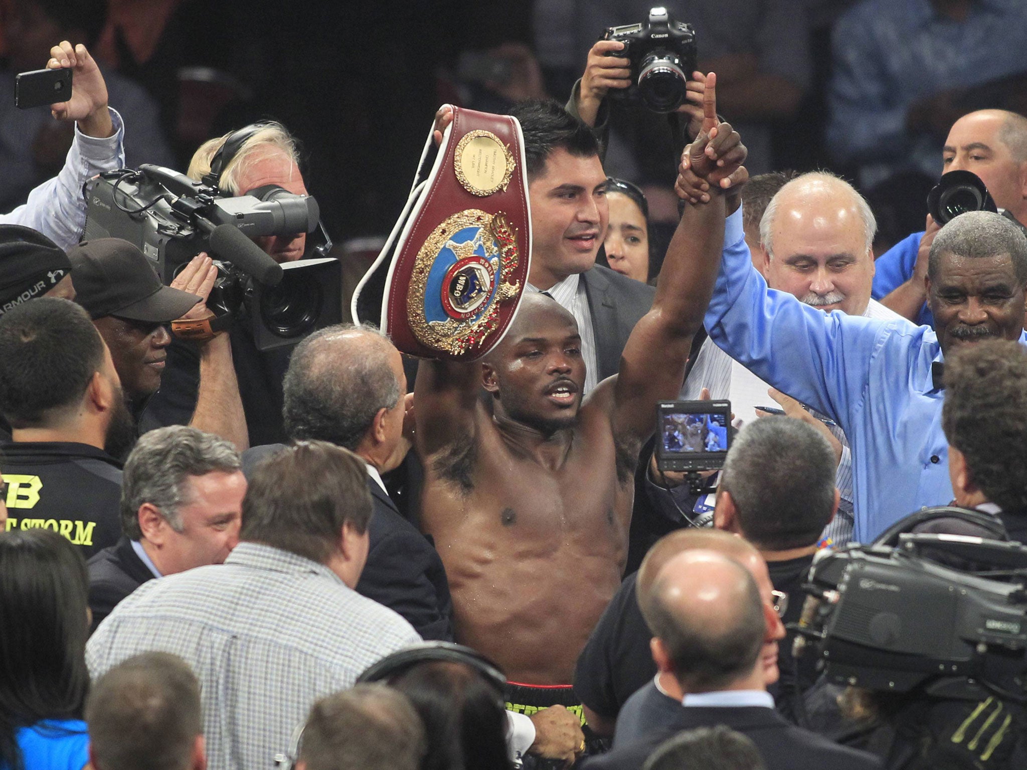 Timothy Bradley raises his WBO belt after beating Juan Manuel Marquez in Las Vegas