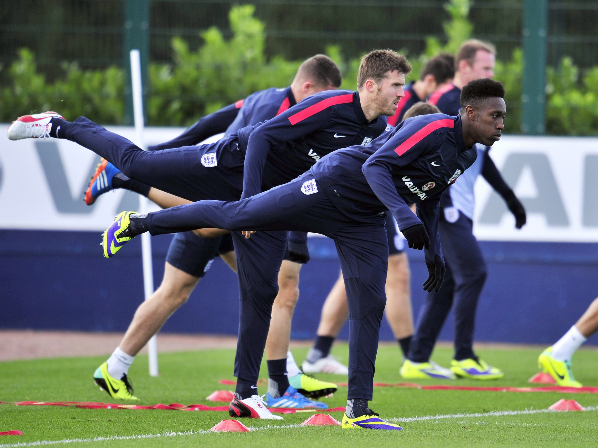 England striker Danny Welbeck (C) does stretching exercises during a training session at London Colney