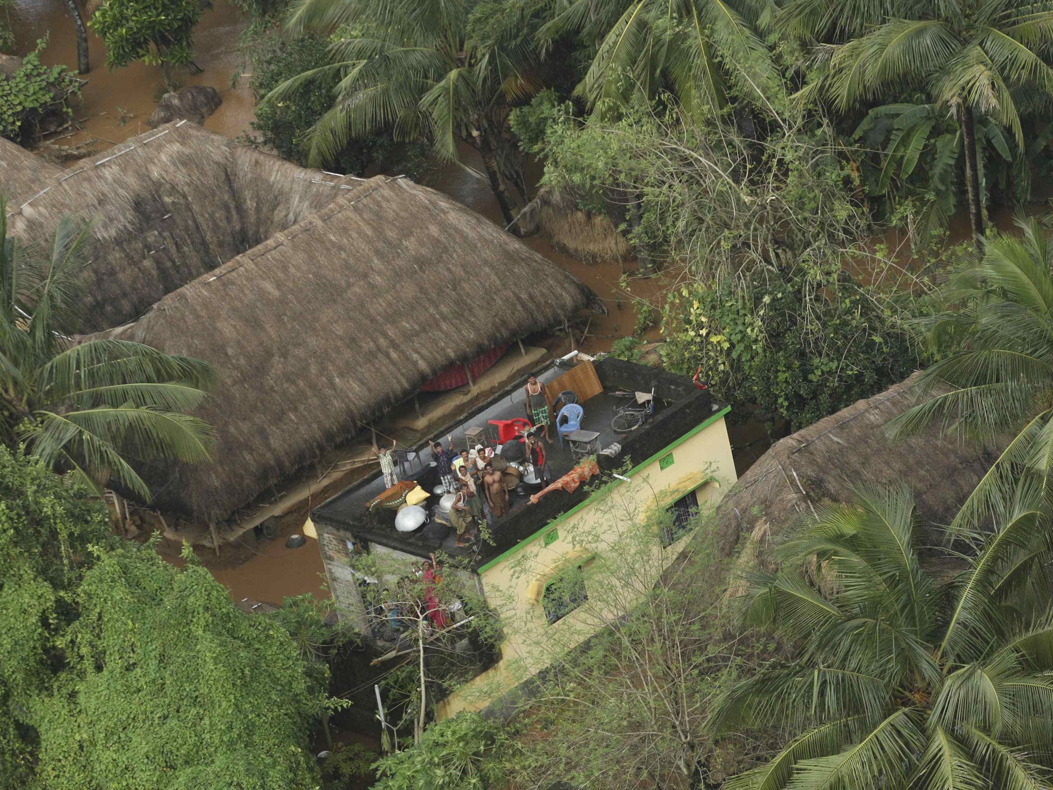 People affected by Cyclone Phailin wait to be rescued and receive relief supplies in the Balasore district of the eastern Indian state of Odisha