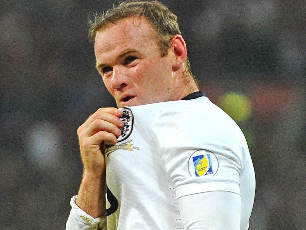 Wayne Rooney kisses the Three Lions in celebration (Getty)