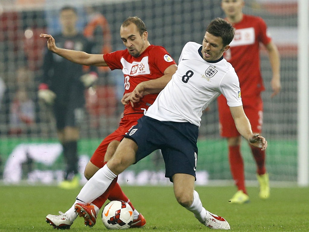 Michael Carrick tackles Poland’s Adrian Mierzejewski