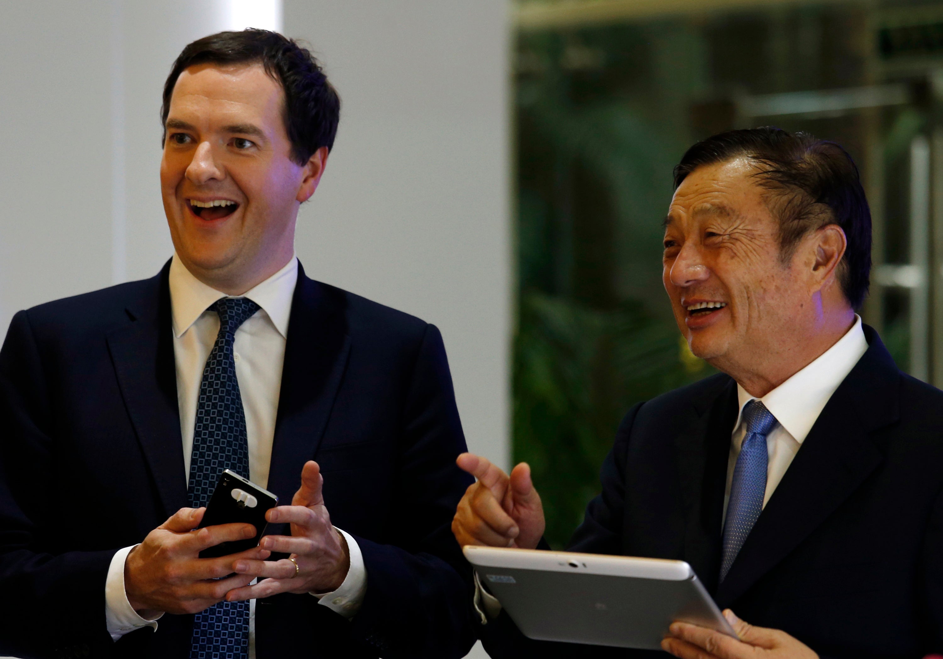 George Osborne (L) and Huawei Chief Executive and founder Ren Zhengfei talk at a campus at Huawei headquarters in the southern Chinese city of Shenzhen.