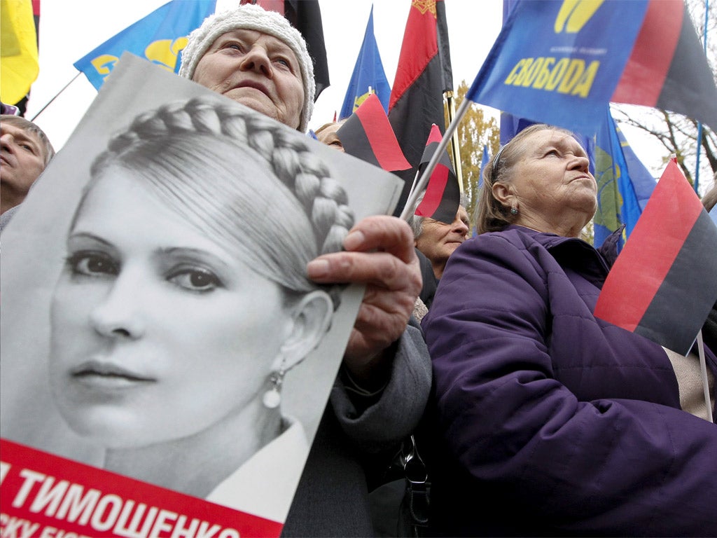 Ukrainians hold Ukrainian Insurgent Army (UPA) flags and portraits of jailed opposition leader Yulia Tymoshenko in Kiev earlier this week