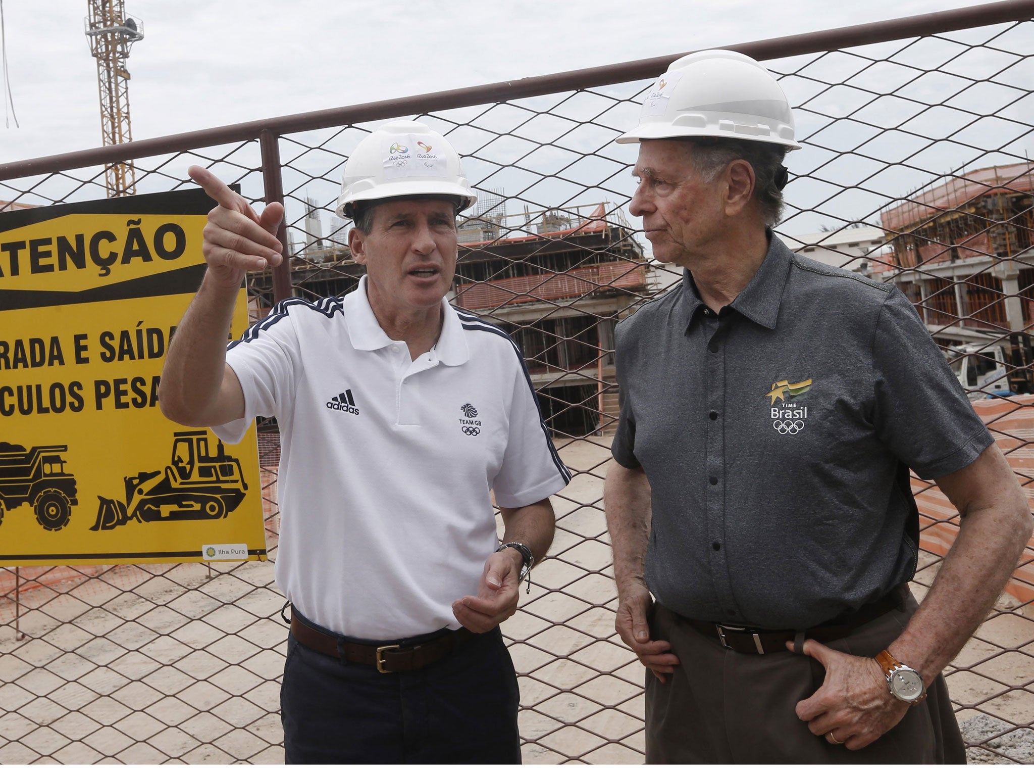 Sebastian Coe, left, visits the Olympic Village site in Rio de Janeiro