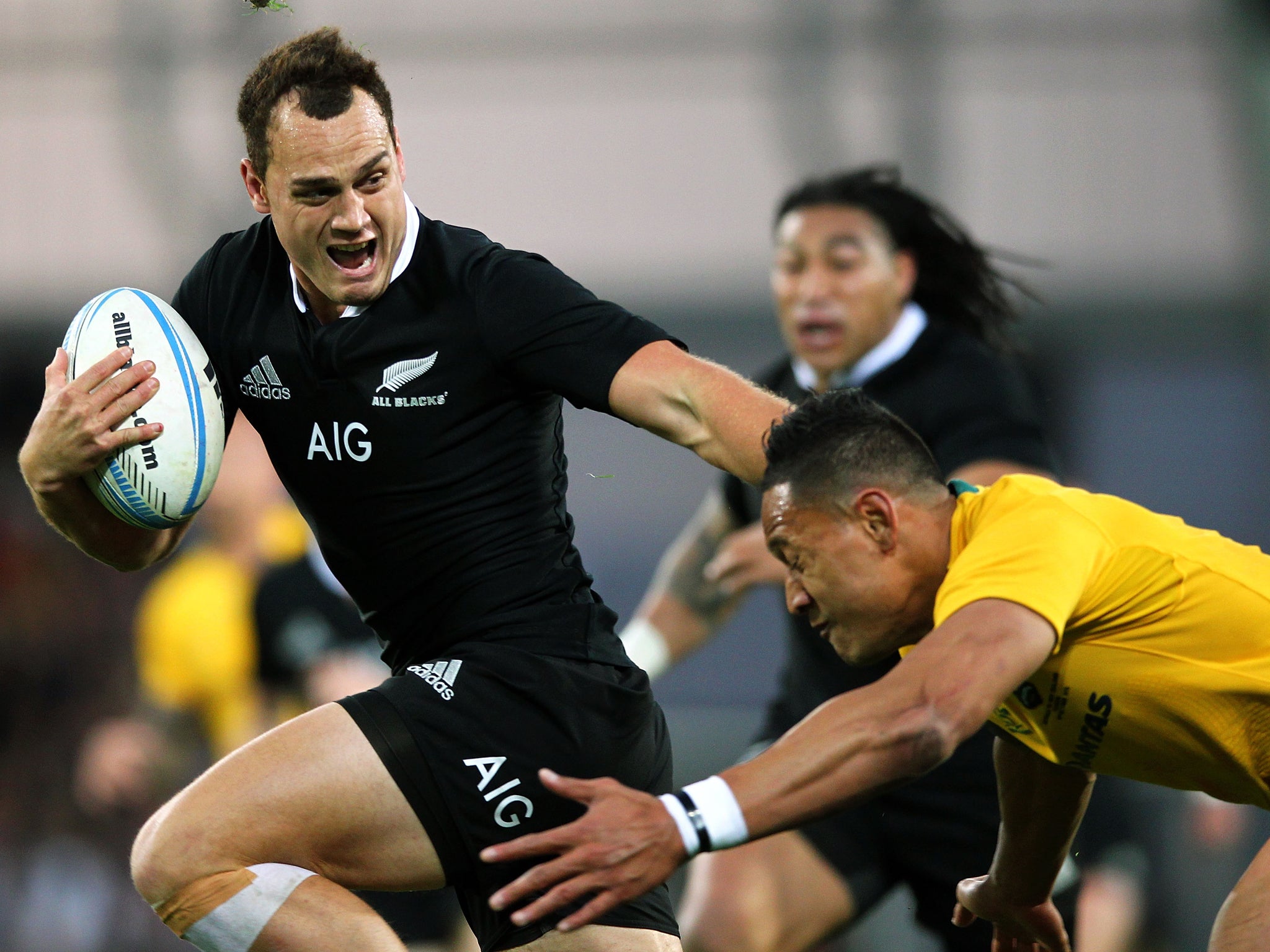 Israel Dagg of New Zealand fends off Israel Folau of Australia