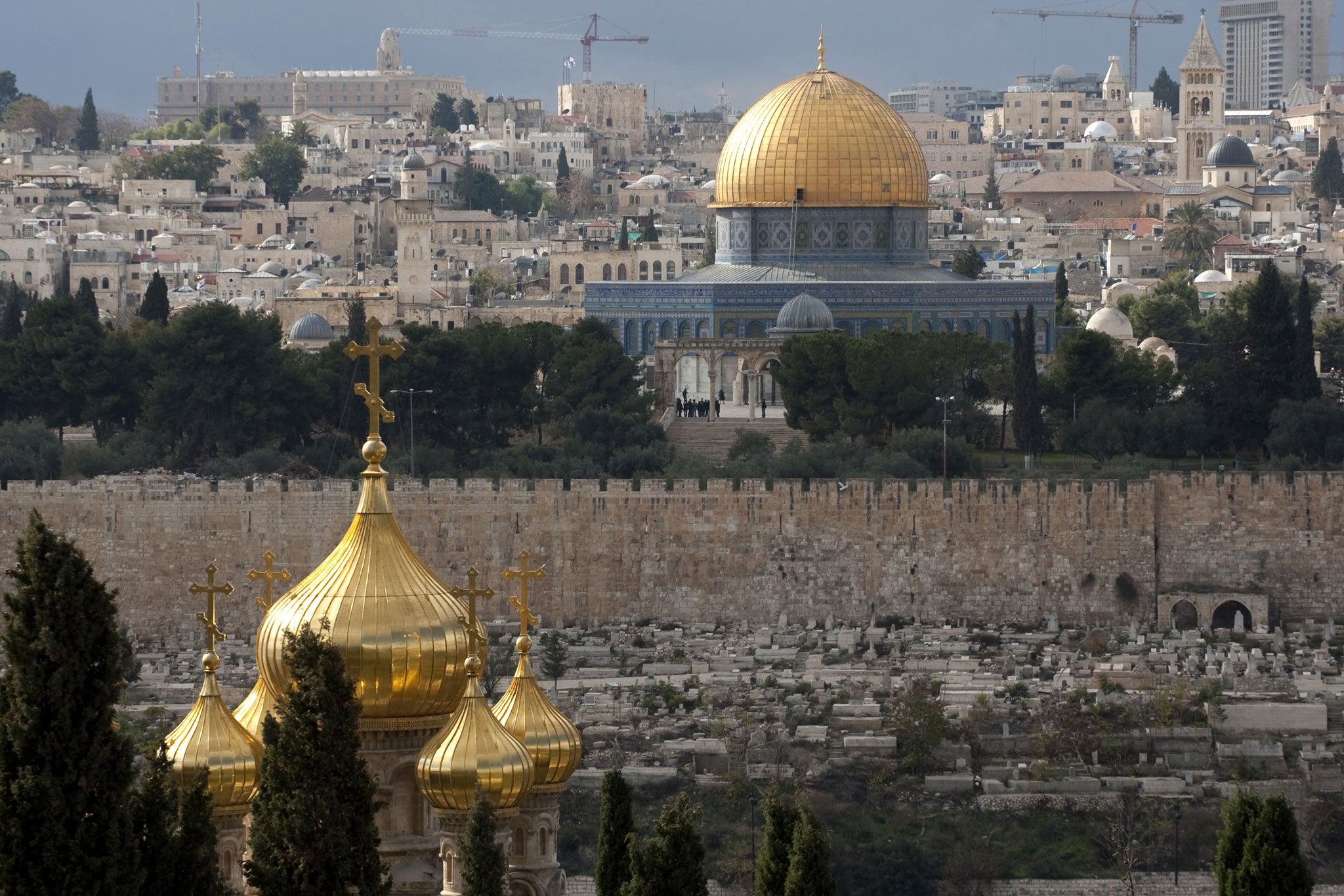 A general view shows the Dome of the Rock (rear) and the Church of St. Mary Magdalene (foreground) in the old city of Jerusalem