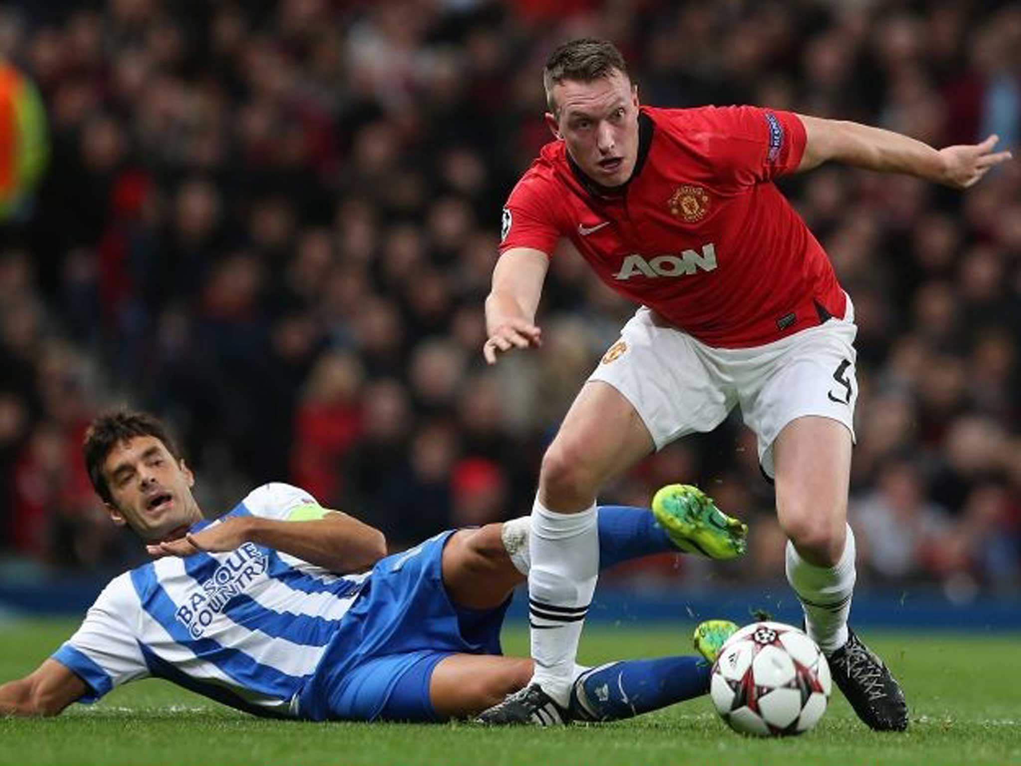 Phil Jones of Manchester United with Xabi Prieto of Real Sociedad