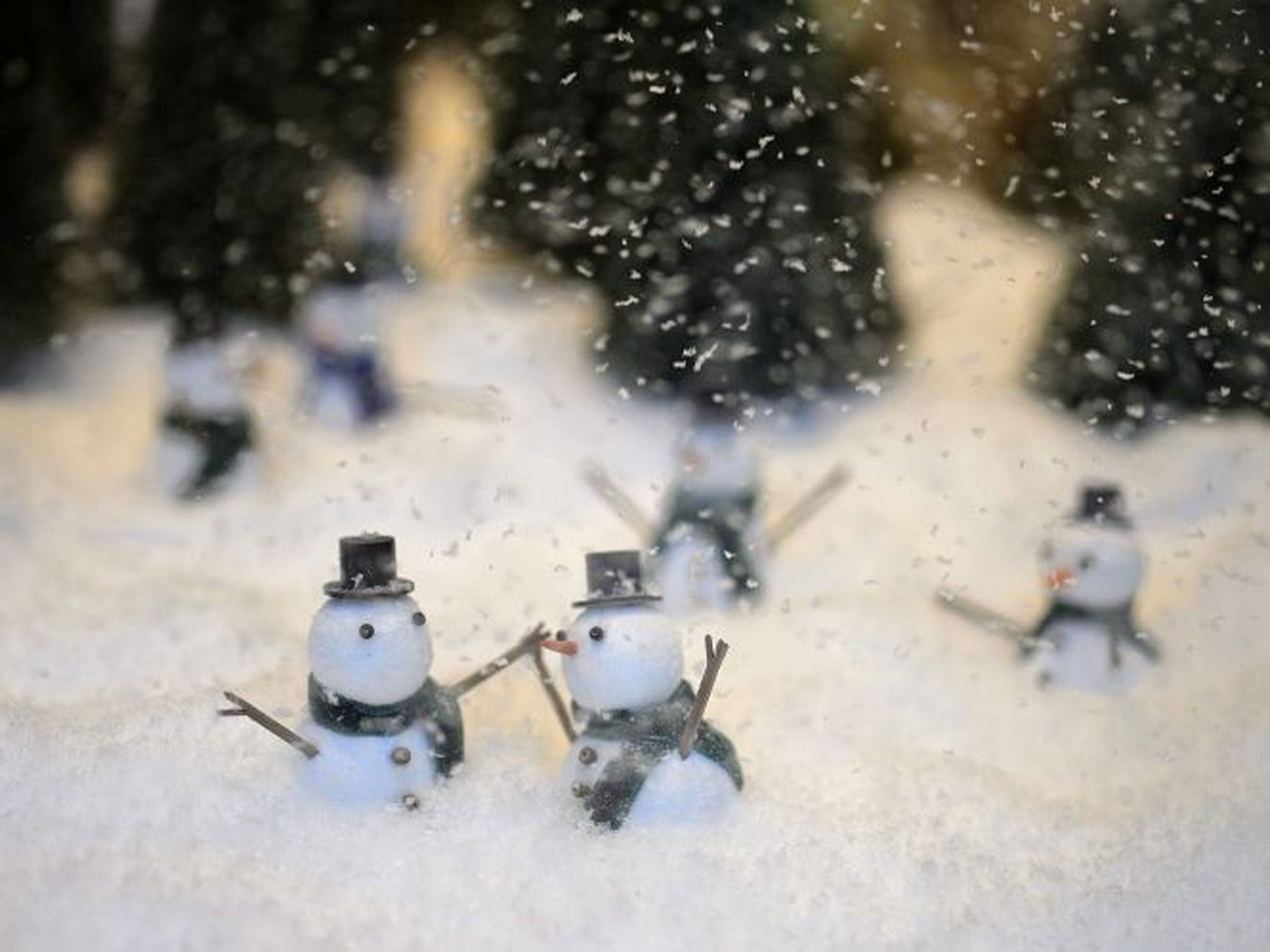Little snowmen playing in the snow in a Selfridges' Christmas window display