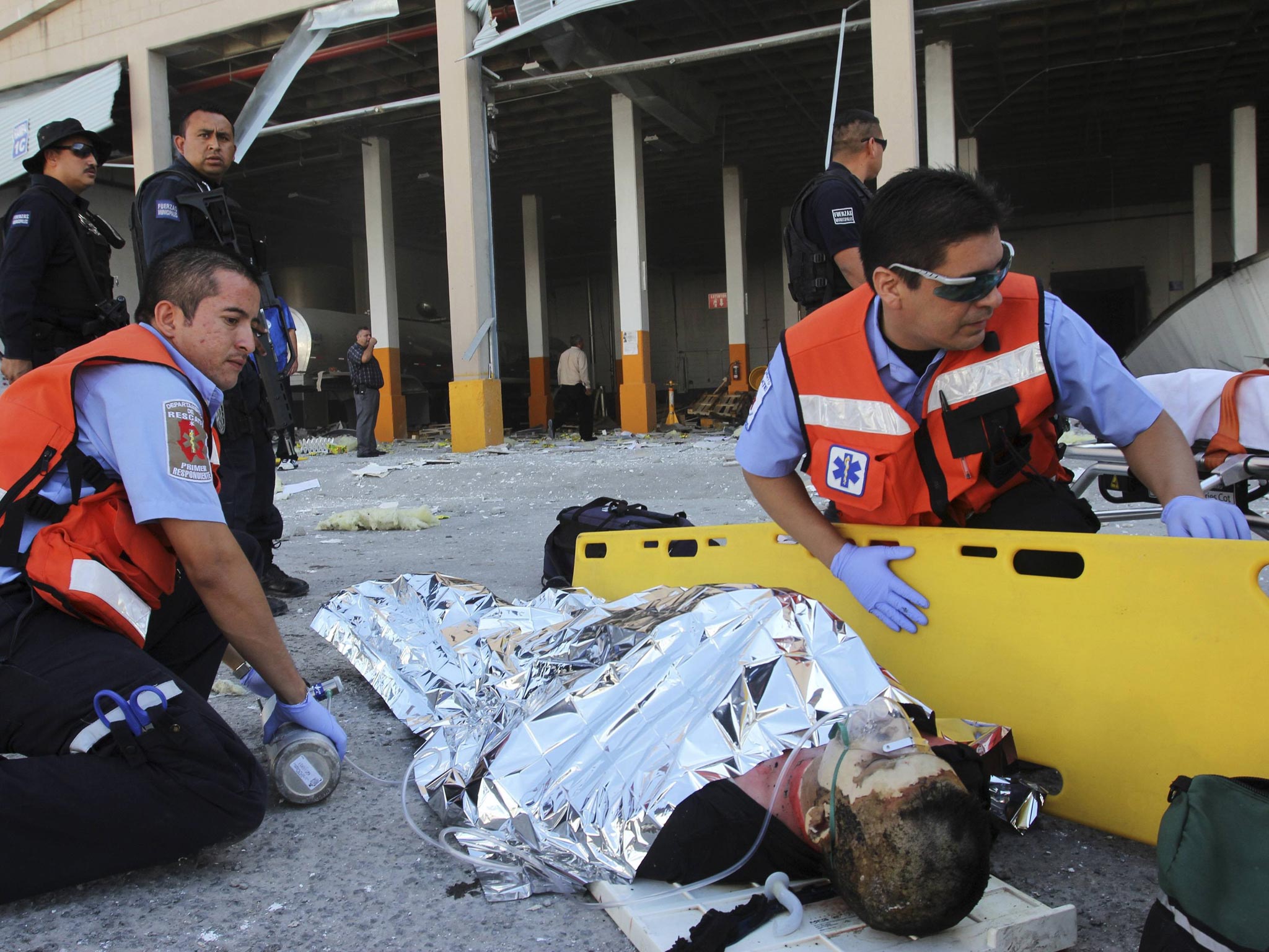 Paramedics attend to an injured person outside the sweet factory
