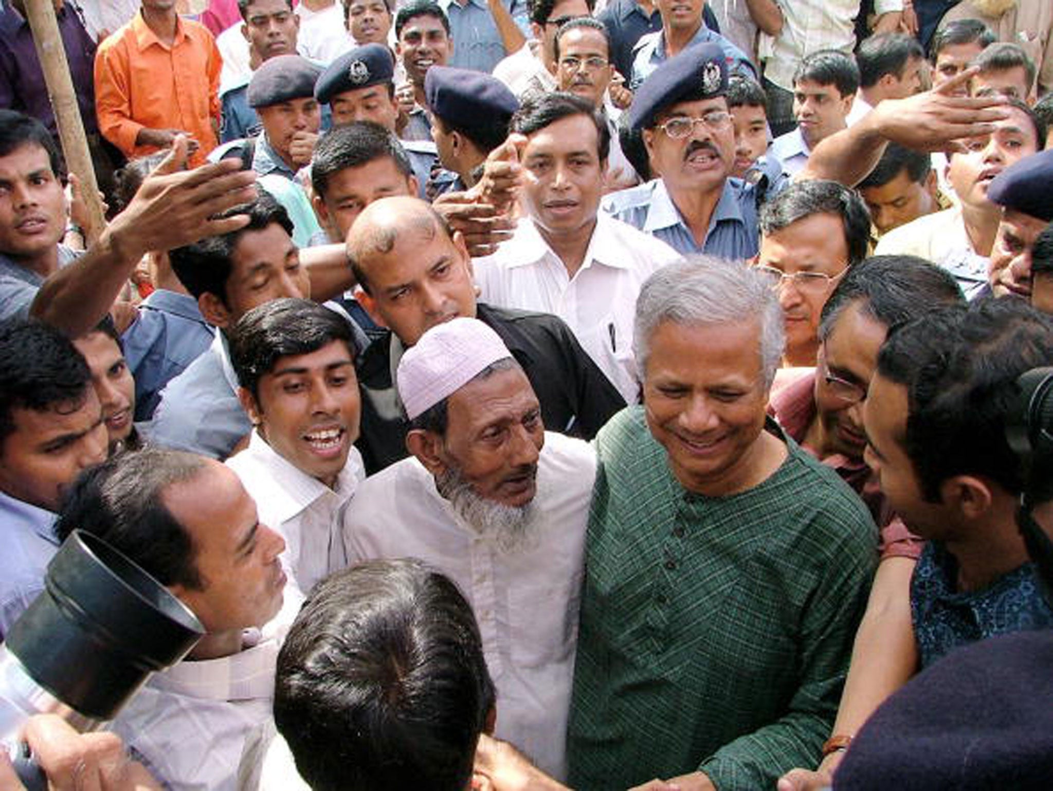 Yunus (in green) is welcomed by locals in Jobra