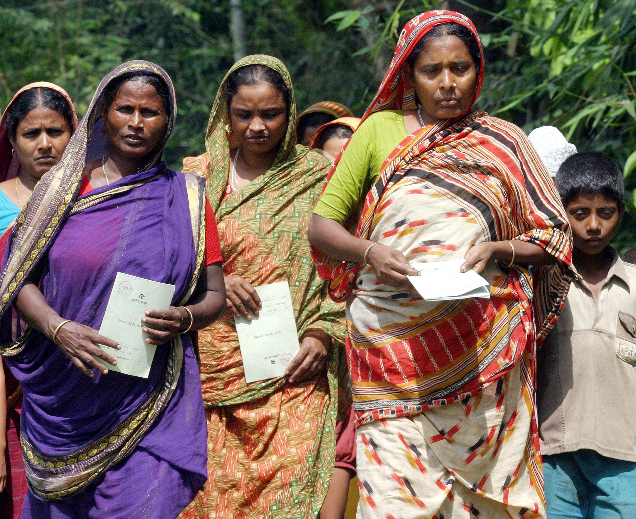 Grameen borrowers walk to the bank to pay their loan instalments in Basta, 45km from Dhaka