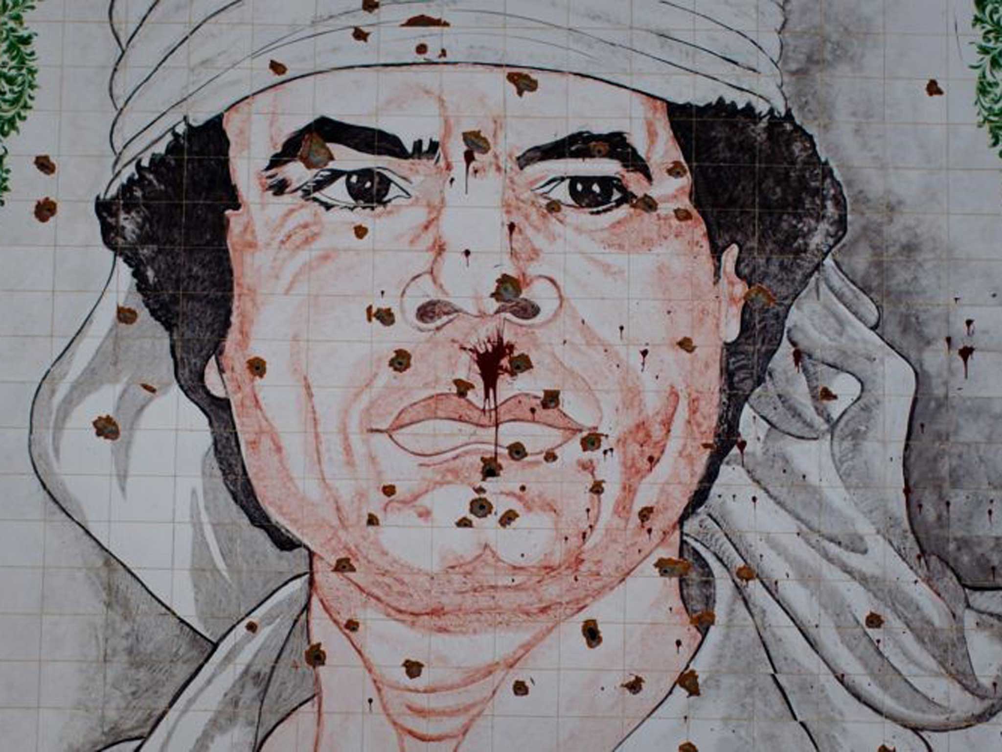 Scars of war: A bullet-riddled Gaddafi mosaic in Tripoli