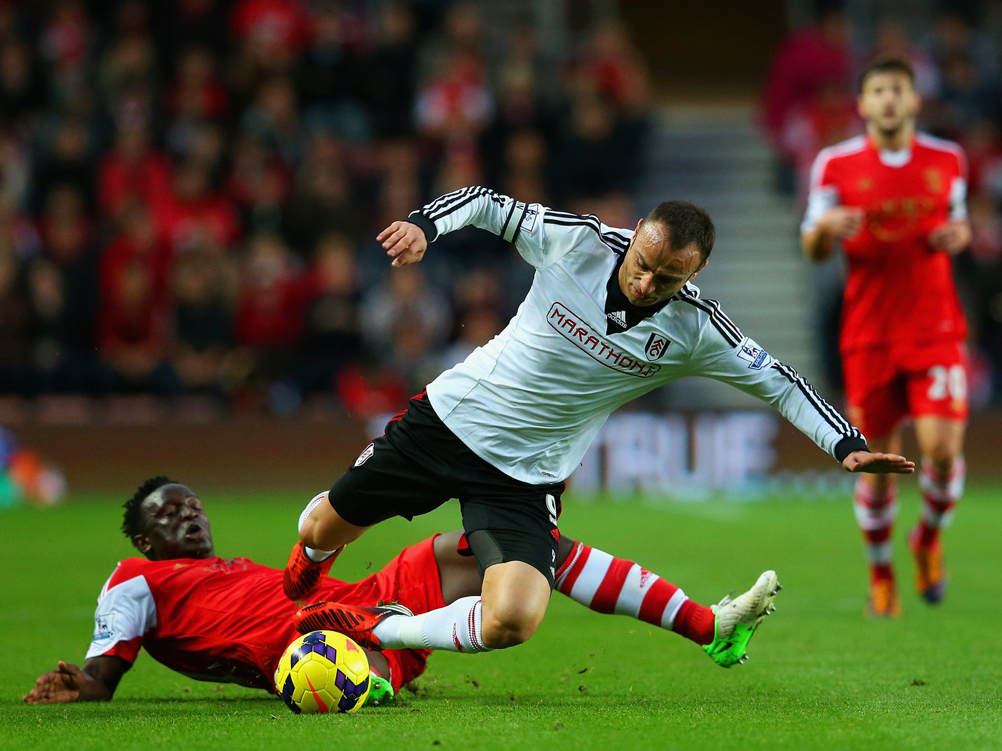 Dimitar Berbatov is stopped in his tracks by Victor Wanyama.