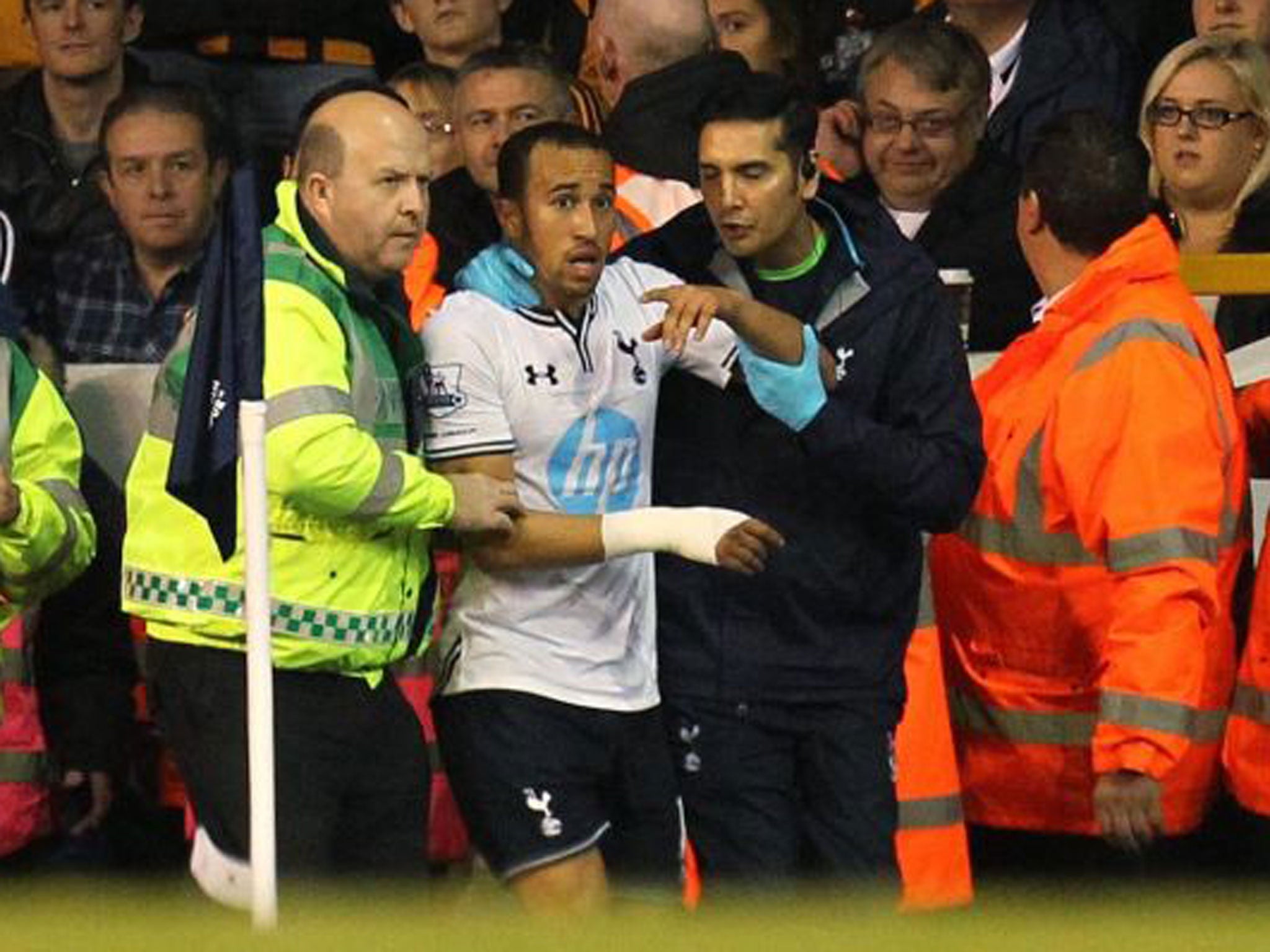 Townsend looks dazed as he is treated by Spurs' medical staff...