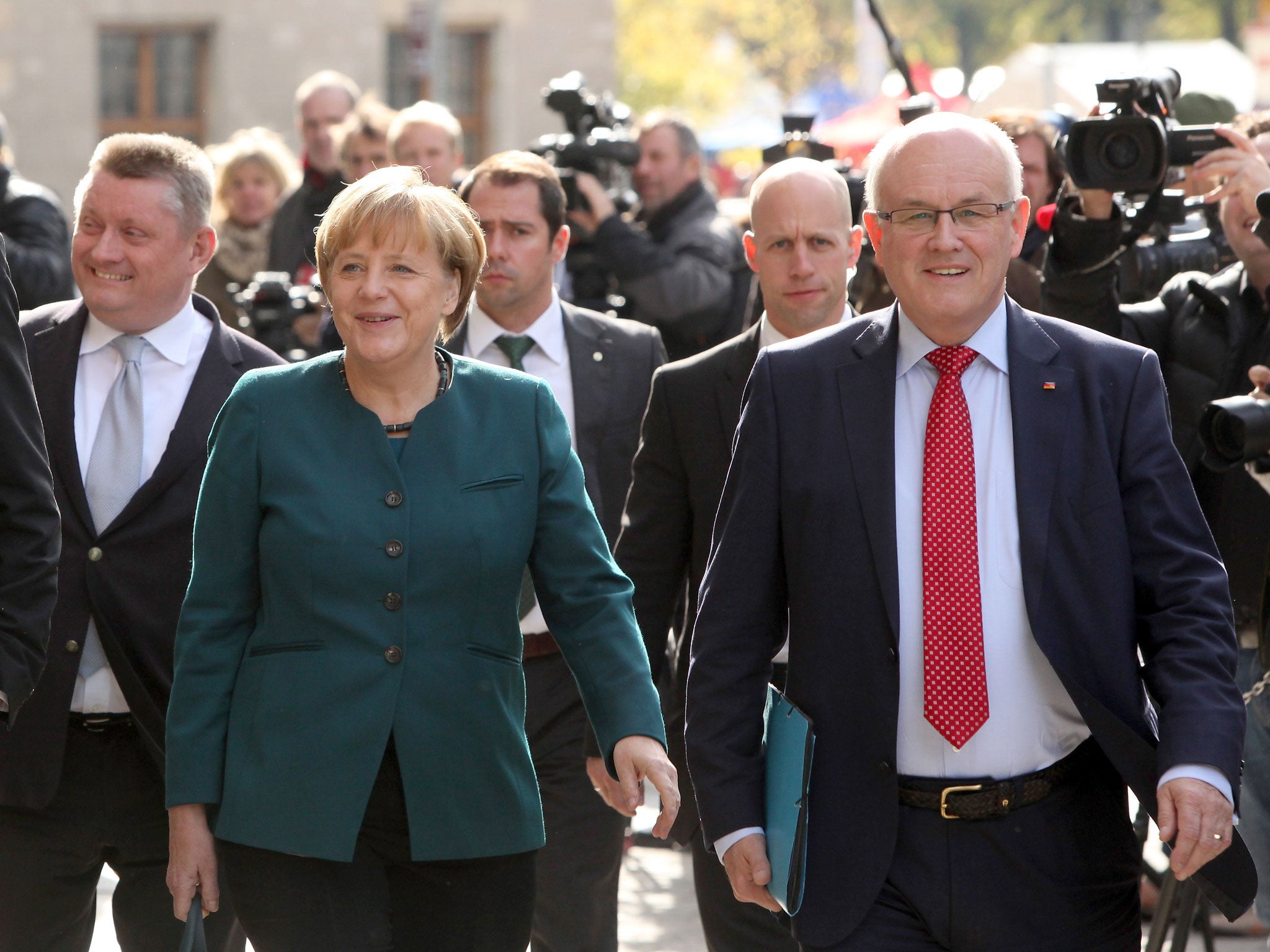 Volker Kauder, right, pictured with Angela Merkel, has demanded that America cease its “world power posturing”