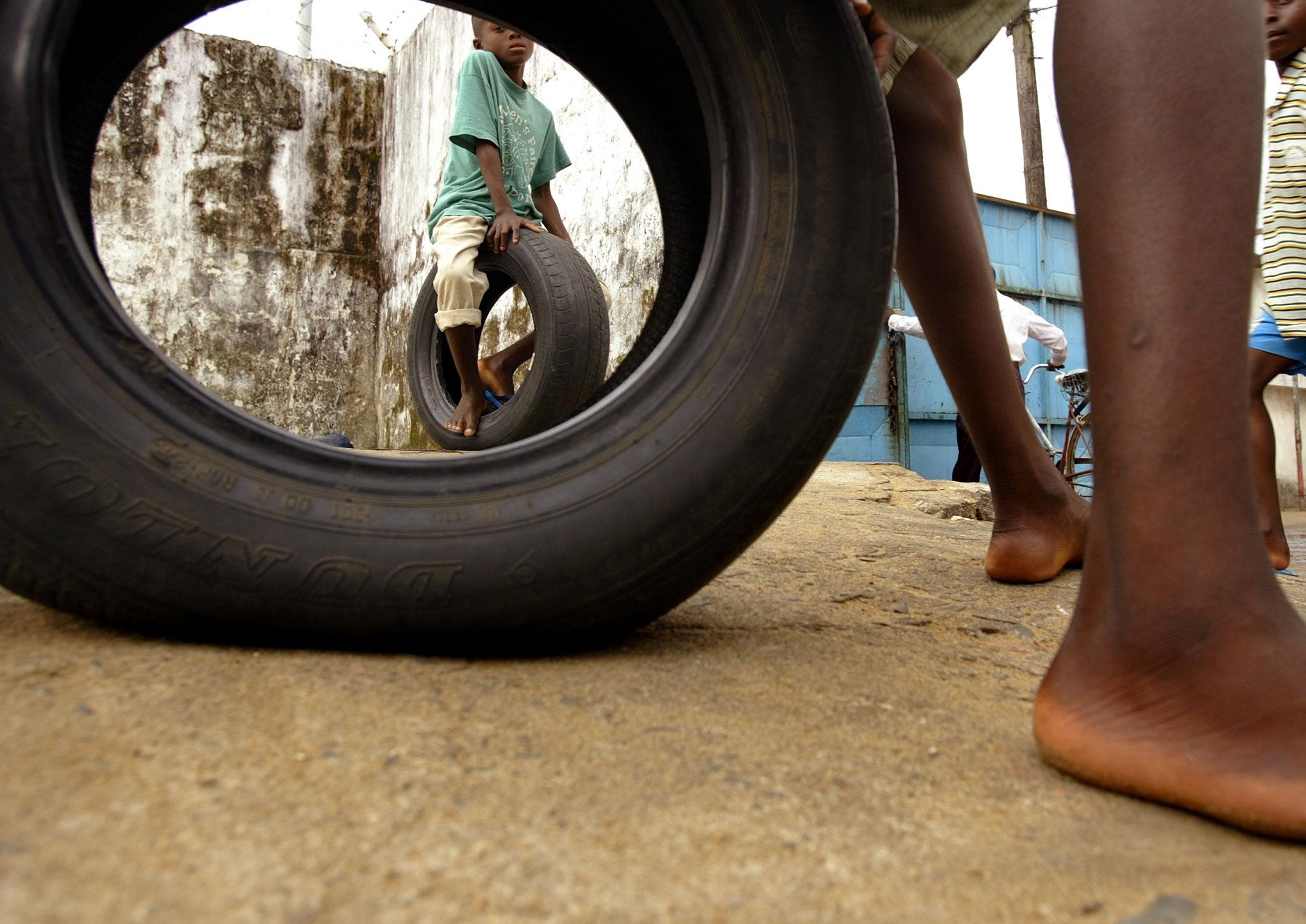 Orphaned boys attend school at a Monrovia orphanage August 22, 2003 in Monrovia, Liberia. In nearby Ghana, Tourism Concern estimates around 90 per cent of children in orphanages actually have parents