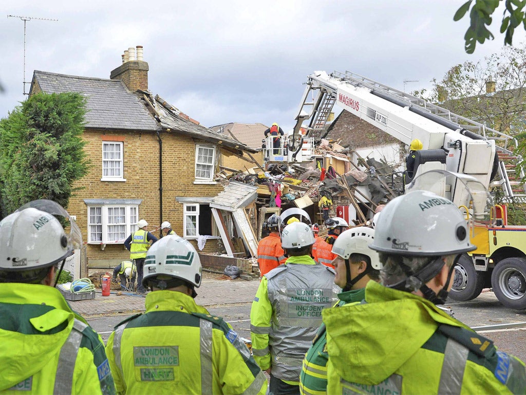 Emergency services work at the scene of a fallen tree at Bath Road in Hounslow