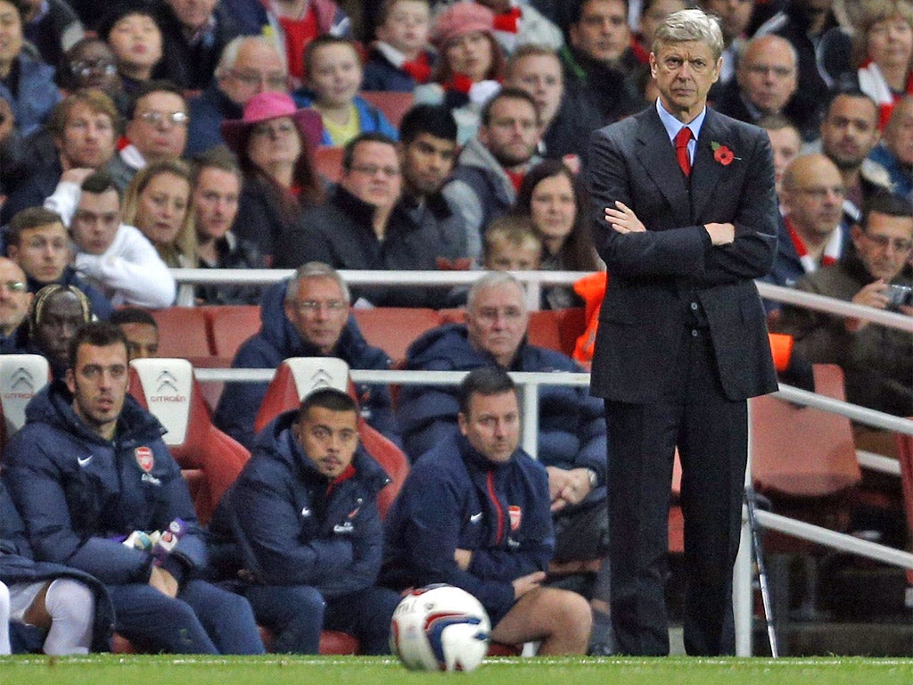 Arsene Wenger looks on from the touchline