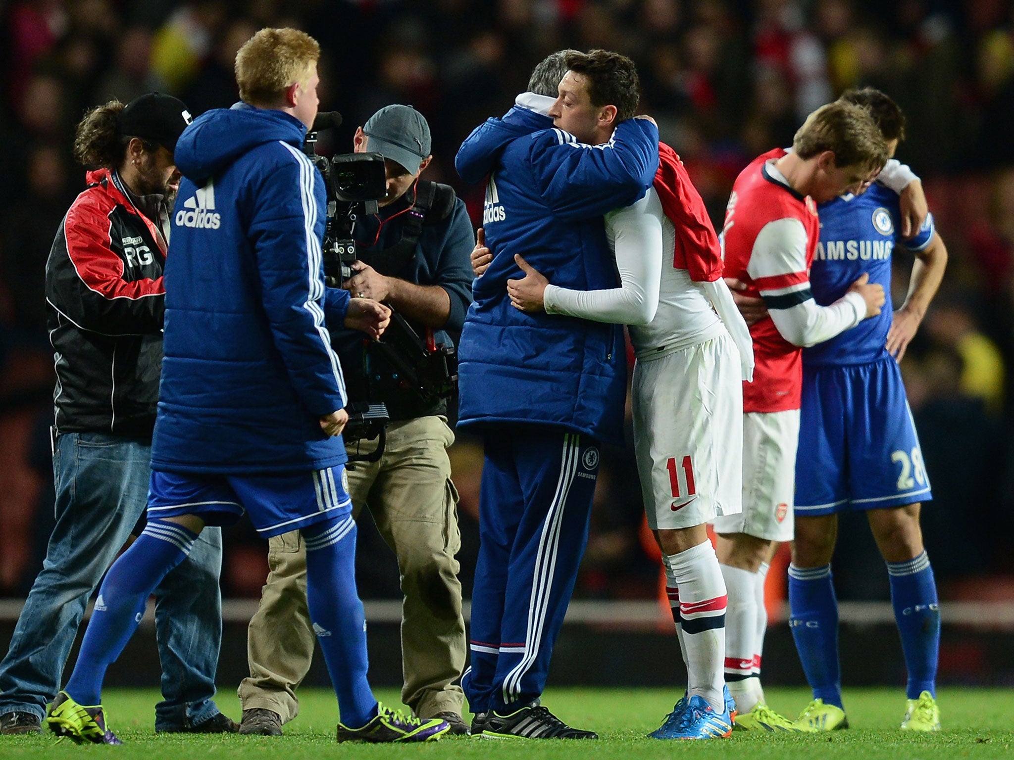 Mourinho and Ozil embrace after the final whistle